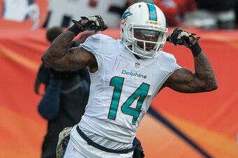 DENVER, CO - NOVEMBER 23:  Wide receiver Jarvis Landry #14 of the Miami Dolphins celebrates a 20-yard reception in the first quarter of a game against the Denver Broncos at Sports Authority Field at Mile High on November 23, 2014 in Denver, Colorado.  (Ph
