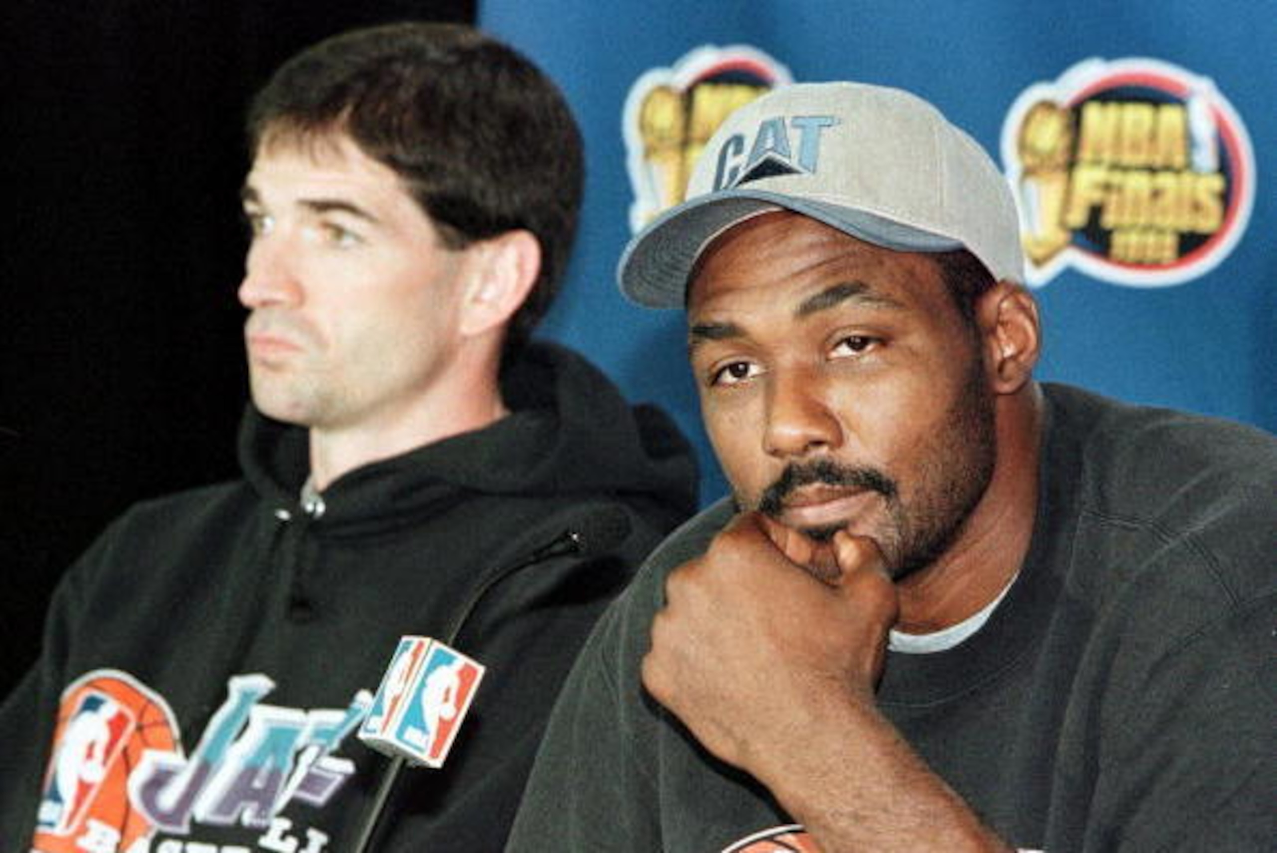 CHICAGO, UNITED STATES:  Karl Malone (R) of the Utah Jazz answers questions while teammate John Stockton (L) looks on 11 June during a press conference after practice for Game Five NBA Finals against the Chicago Bulls at the United Center in Chicago, IL. 