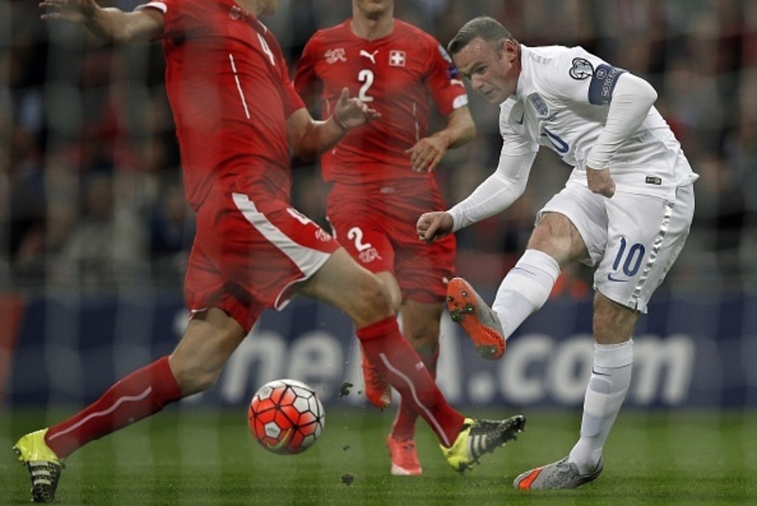 Switzerland's Timm Klose (L) challenges England's striker Wayne Rooney as he makes an unsuccessful shot during the Euro 2016 qualifying group E football match between England and Switzerland at Wembley Stadium in west London on September 8, 2015.    AFP P