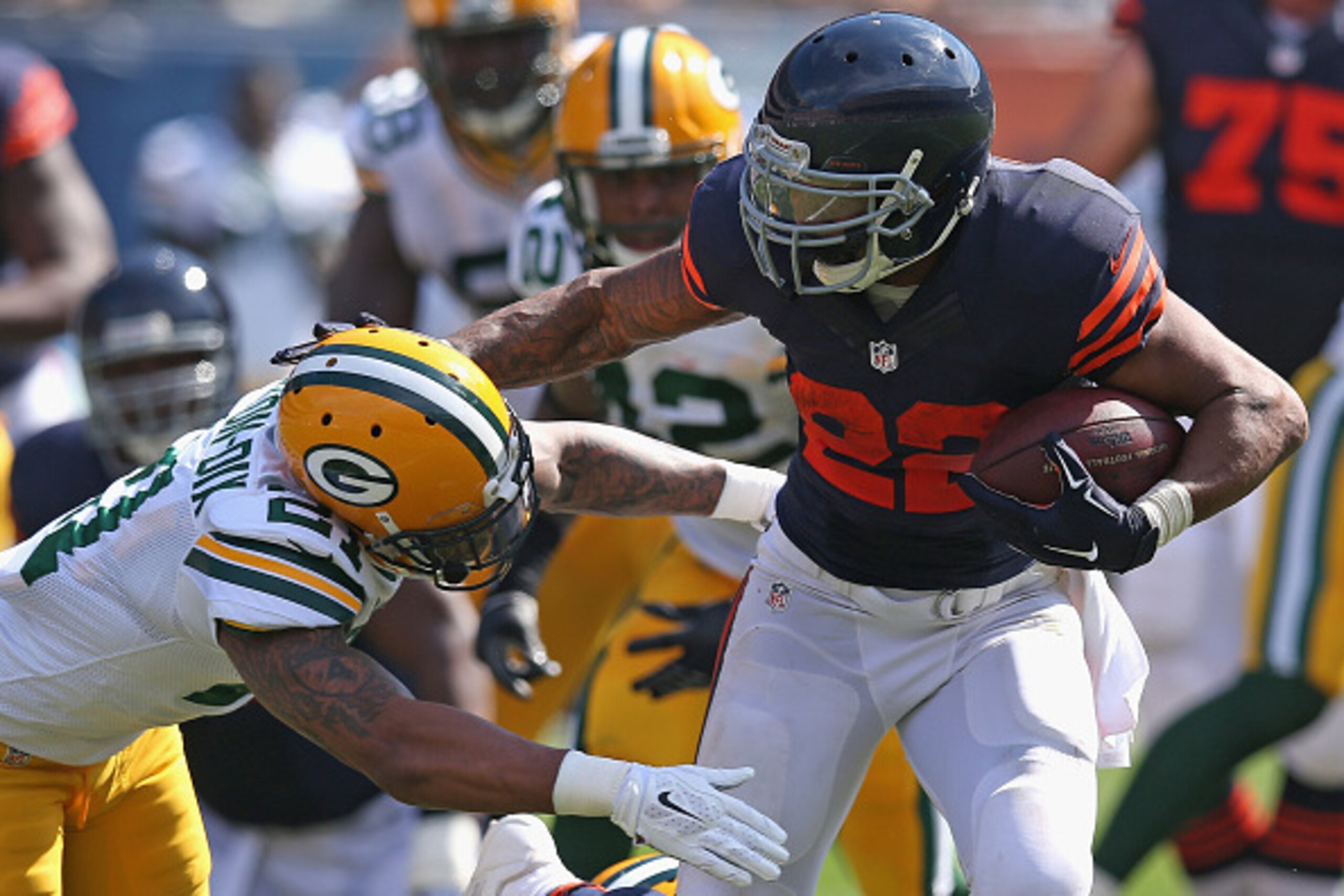 CHICAGO, IL - SEPTEMBER 28:  Matt Forte #22 of the Chicago Bears tries to avoid a tackle by Ha Ha Clinton-Dix #21 of the Green Bay Packers during the first quarter at Soldier Field on September 28, 2014 in Chicago, Illinois. The Packers defeated the Bears