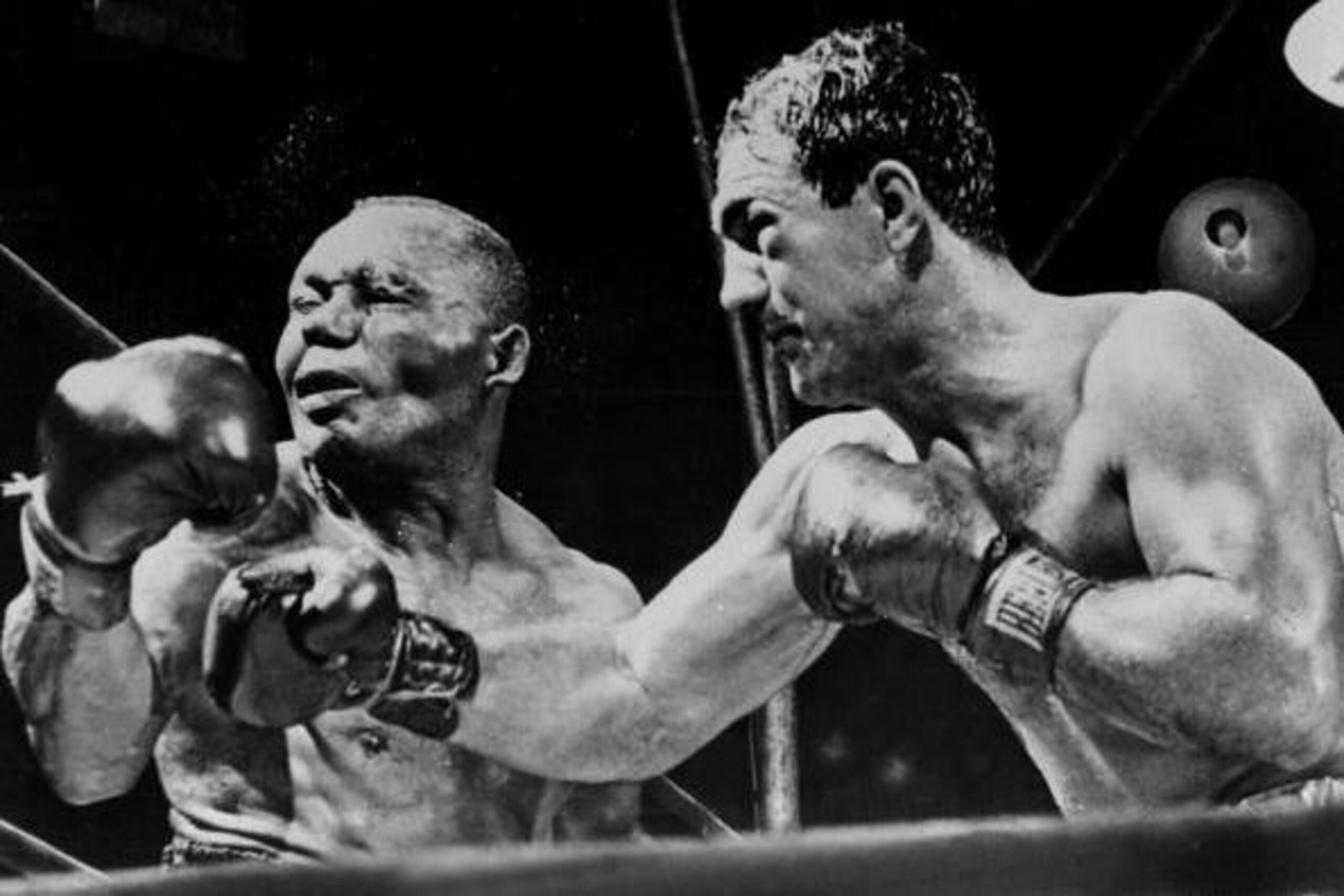 NEW YORK, NY - SEPTEMBER 1:  American boxing champion Rocky Marciano (R) throws a right swing to his country fellow heavyweight boxing world champion Joe Walcott, September 1952 in New York, in the fifteenth round of their fight for the title that he take