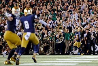 SOUTH BEND, IN - SEPTEMBER 05: Malik Zaire #8 of the Notre Dame Fighting Irish and Mike McGlinchey #68 (L) celebrate a touchdown pass to William Fuller #7 (R) against the Texas Longhorns during the third quarter at Notre Dame Stadium on September 5, 2015 