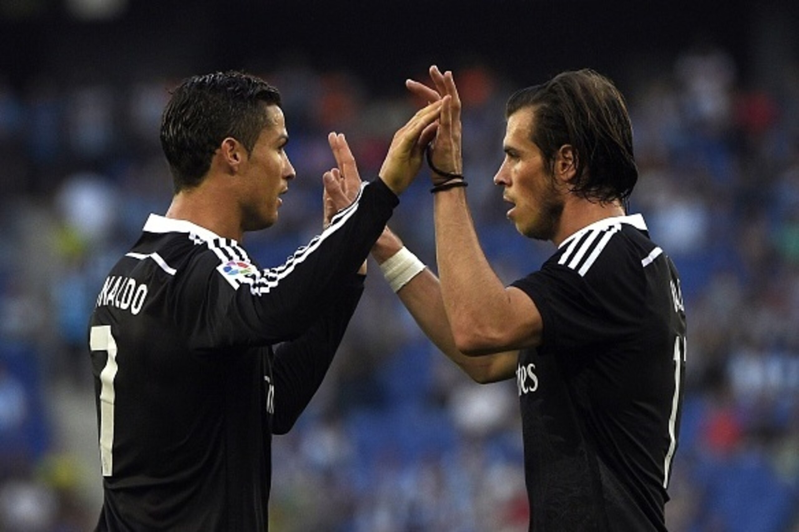 Real Madrid's Portuguese forward Cristiano Ronaldo (L) and Real Madrid's Welsh forward Gareth Bale (R) celebrate a goal during the Spanish league football match RCD Espanyol vs Real Madrid CF at the Cornella-El Prat stadium in Cornella de Llobregat on May