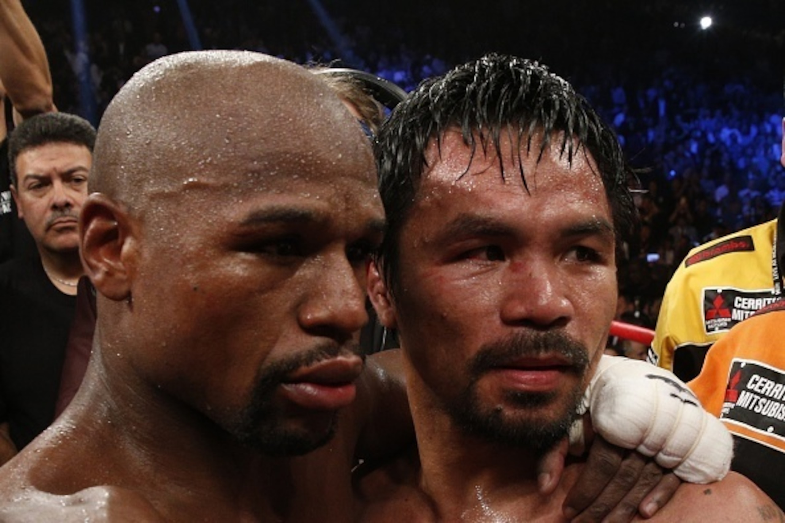 Floyd Mayweather Jr., hugs Manny Pacquiao after defeating Pacquiao in their welterweight unification bout on May 2, 2015 at the MGM Grand Garden Arena in Las Vegas, Nevada. AFP PHOTO / JOHN GURZINKSI        (Photo credit should read JOHN GURZINSKI/AFP/Get