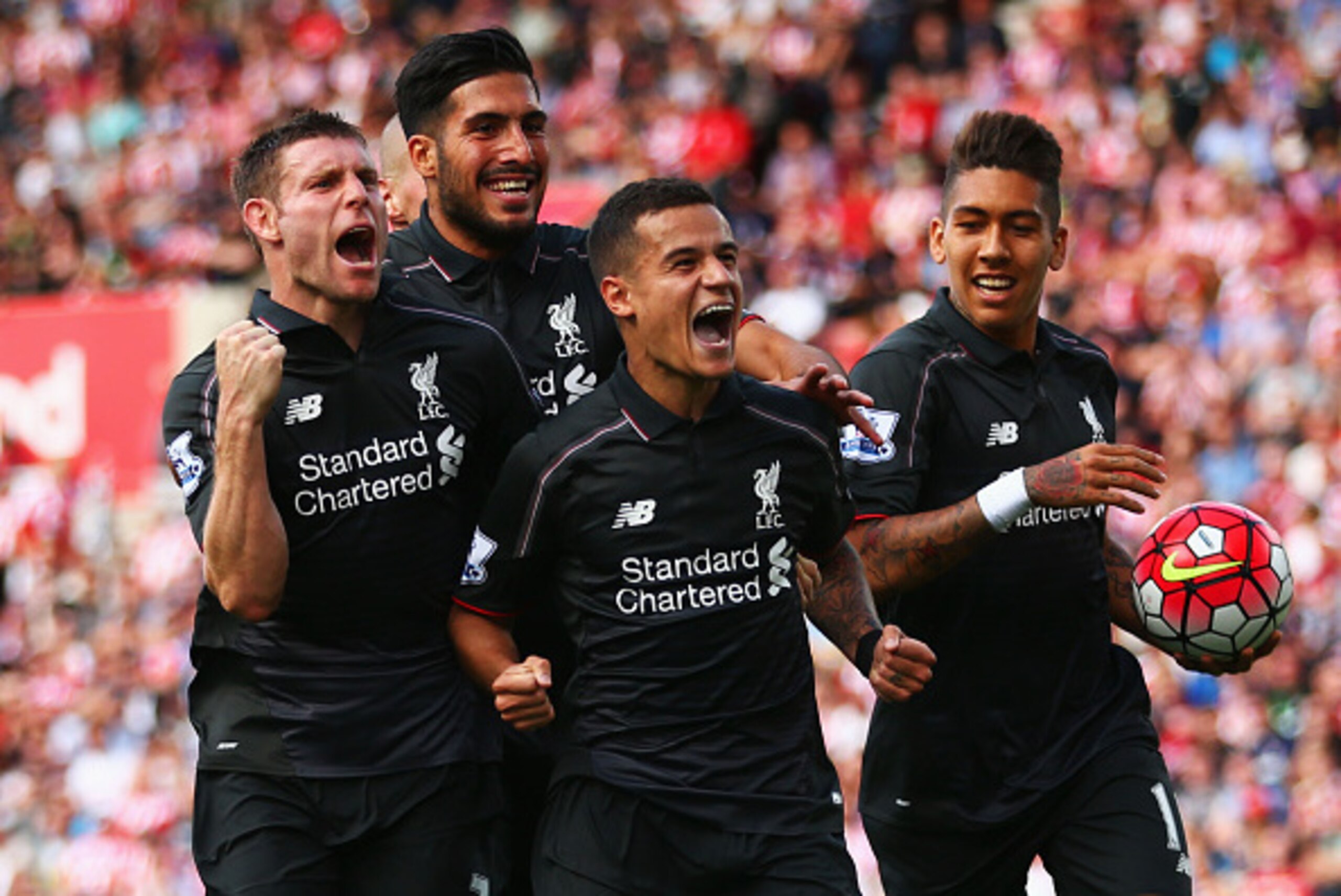 STOKE ON TRENT, ENGLAND - AUGUST 09:  Philippe Coutinho of Liverpool (10) celebrates with team mates James Milner, Emre Can and Roberto Firmino of Liverpool as he scores their first goal during the Barclays Premier League match between Stoke City and Live
