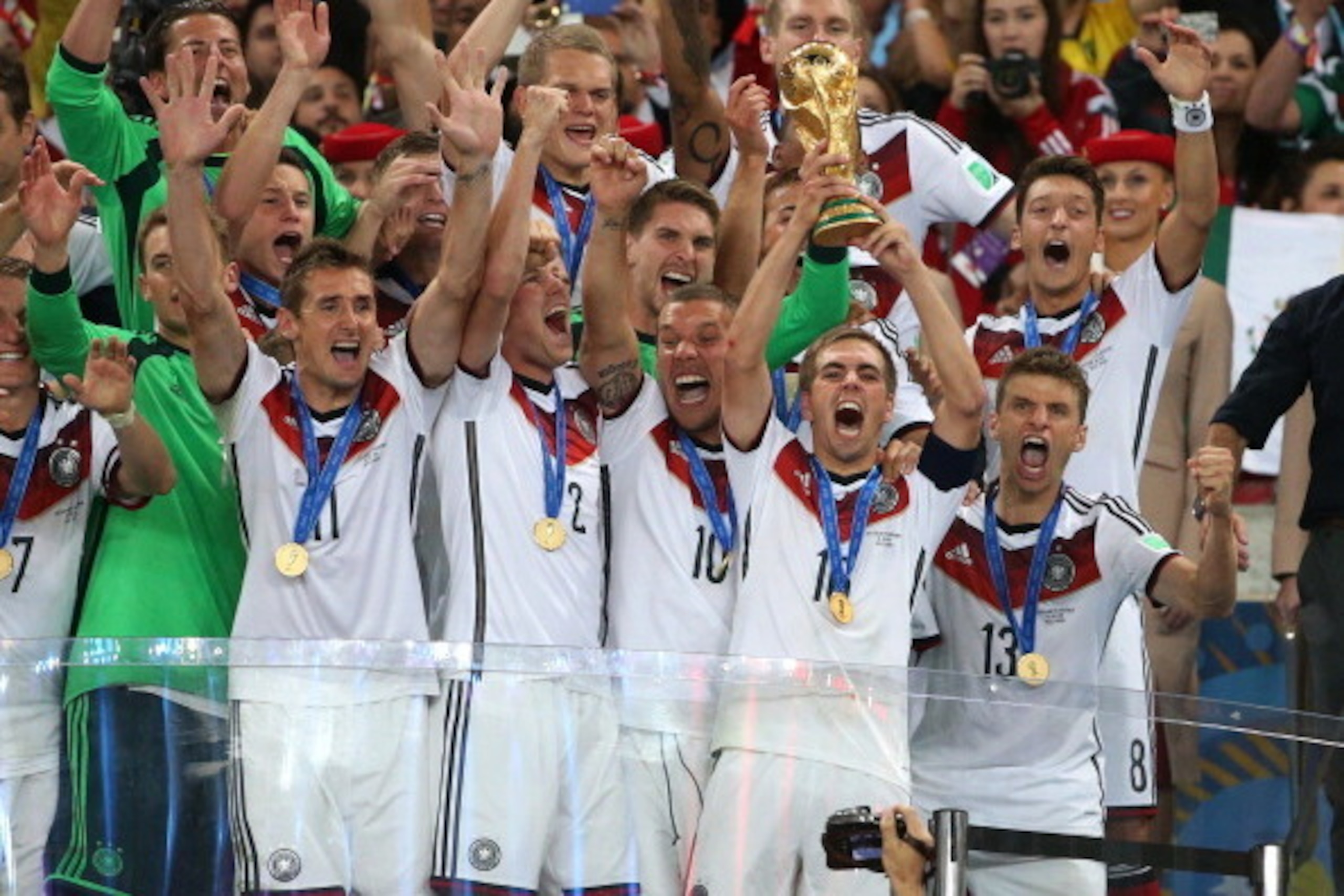 RIO DE JANEIRO, BRAZIL - JULY 13: Philipp Lahm, captain of Germany holds the trophy and celebrate the victory with his teammates during the trophy presentation after the 2014 FIFA World Cup Brazil Final match between Germany and Argentina at Estadio Marac