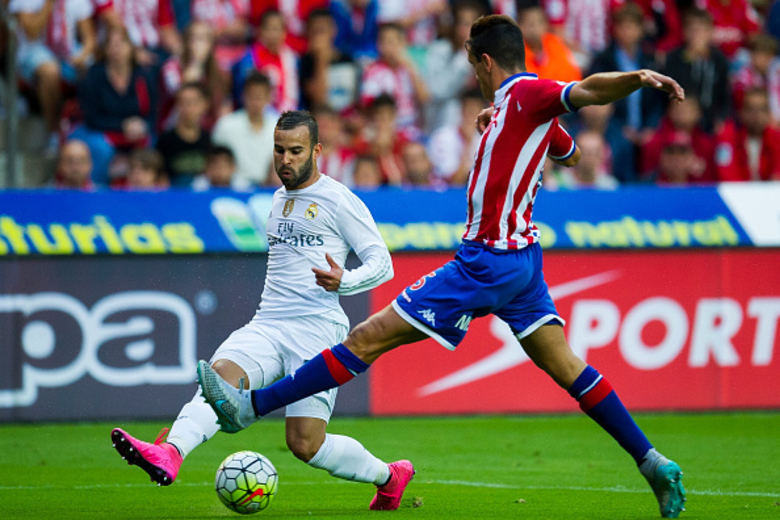 GIJON, SPAIN - AUGUST 23: Jese Rodriguez of Real Madrid duels for the ball with Bernardo Espinosa of Real Sporting de Gijon during the La Liga match between Sporting Gijon and Real Madrid at Estadio El Molinon on August 23, 2015 in Gijon, Spain.  (Photo b