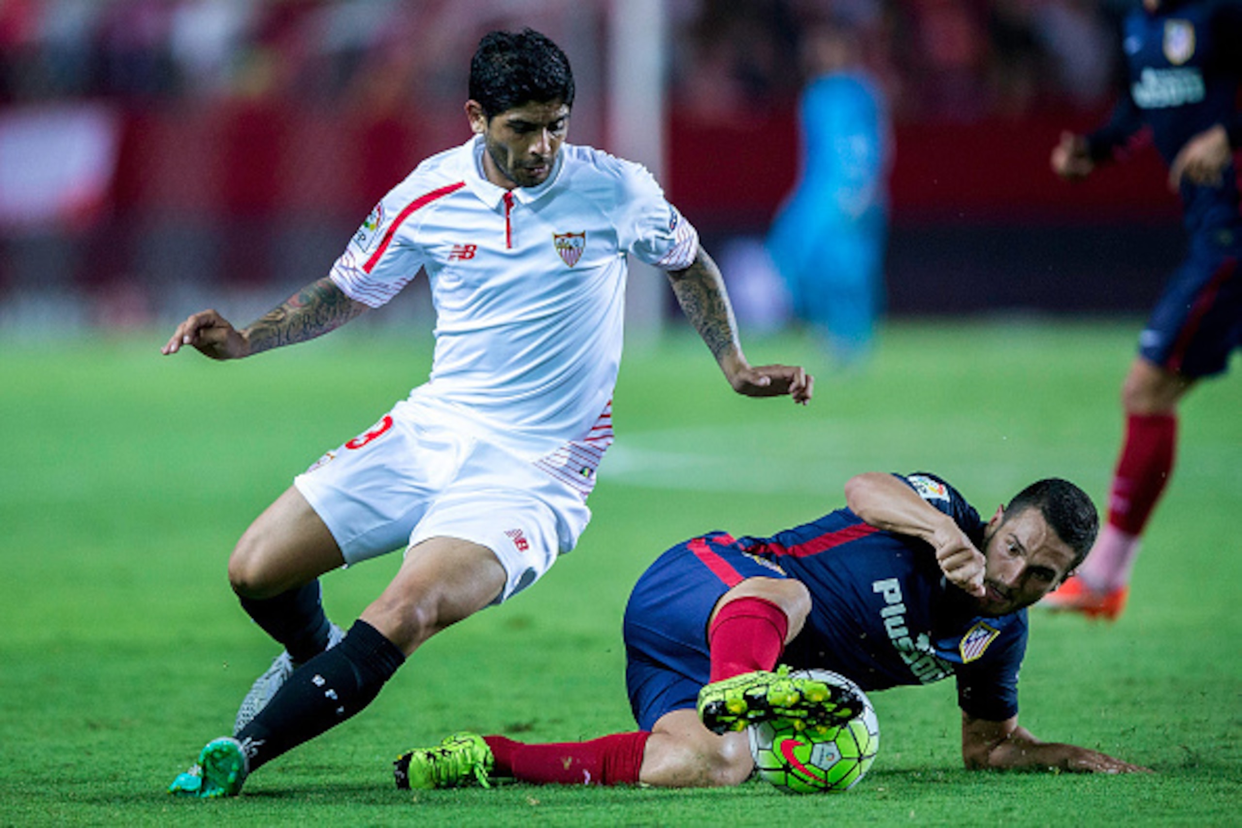 SEVILLE, SPAIN - AUGUST 30: Koke (R) of Atletico de Madrid competes for the ball with Ever Banega (L) of Sevilla FC during the La Liga match between Sevilla FC and Club Atletico de Madrid at Estadio Ramon Sanchez Pizjuan on August 30, 2015 in Seville, Spa
