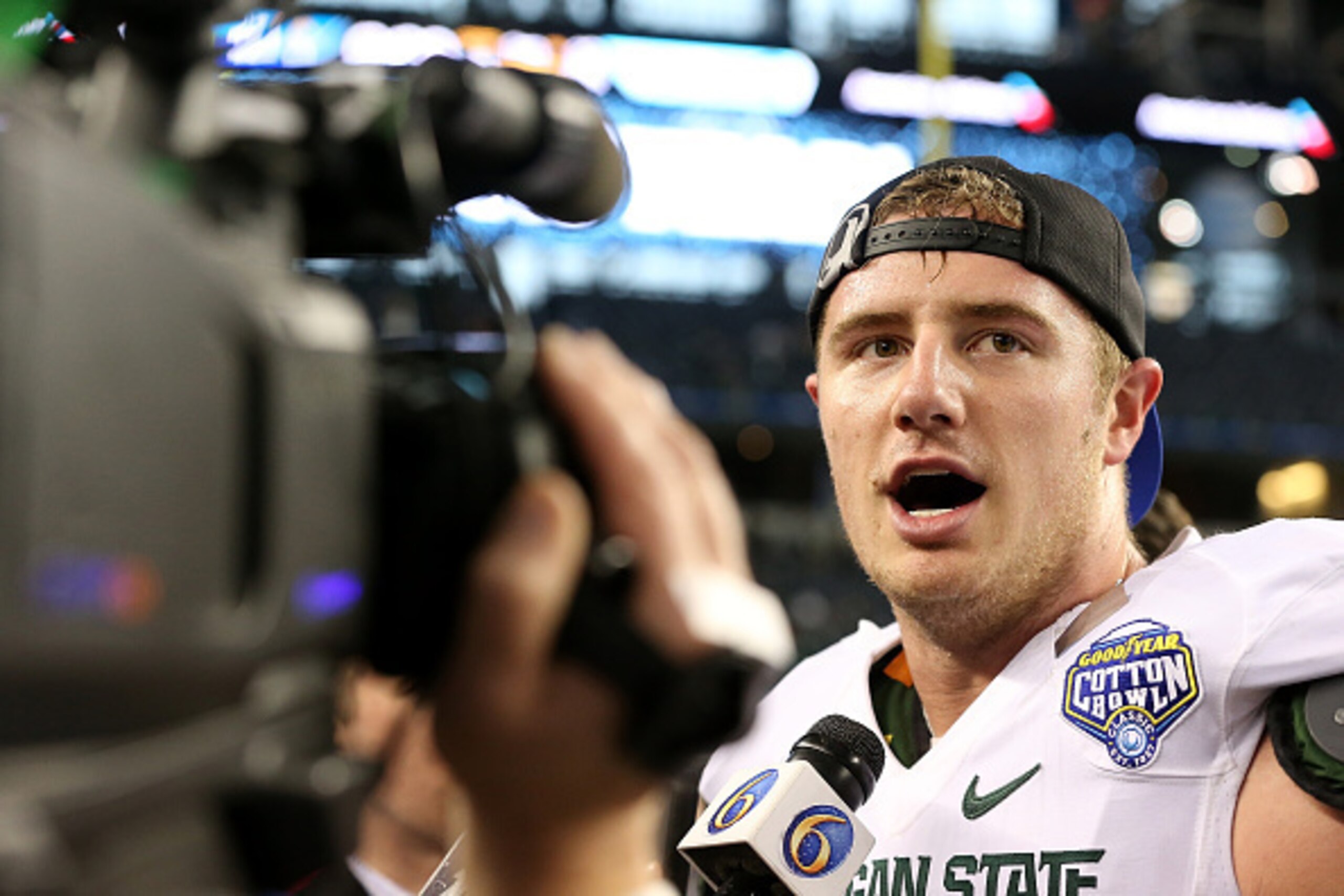 ARLINGTON, TX - JANUARY 01:  Connor Cook #18 of the Michigan State Spartans talks to reporters after defeating the Baylor Bears during the Goodyear Cotton Bowl Classic at AT&T Stadium on January 1, 2015 in Arlington, Texas.  (Photo by Sarah Glenn/Getty Im