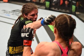 FAIRFAX, VA - APRIL 04:   (L-R) Lauren Murphy punches Liz Carmouche in their women's bantamweight fight during the UFC Fight Night event at the Patriot Center on April 4, 2015 in Fairfax, Virginia. (Photo by Josh Hedges/Zuffa LLC/Zuffa LLC via Getty Image