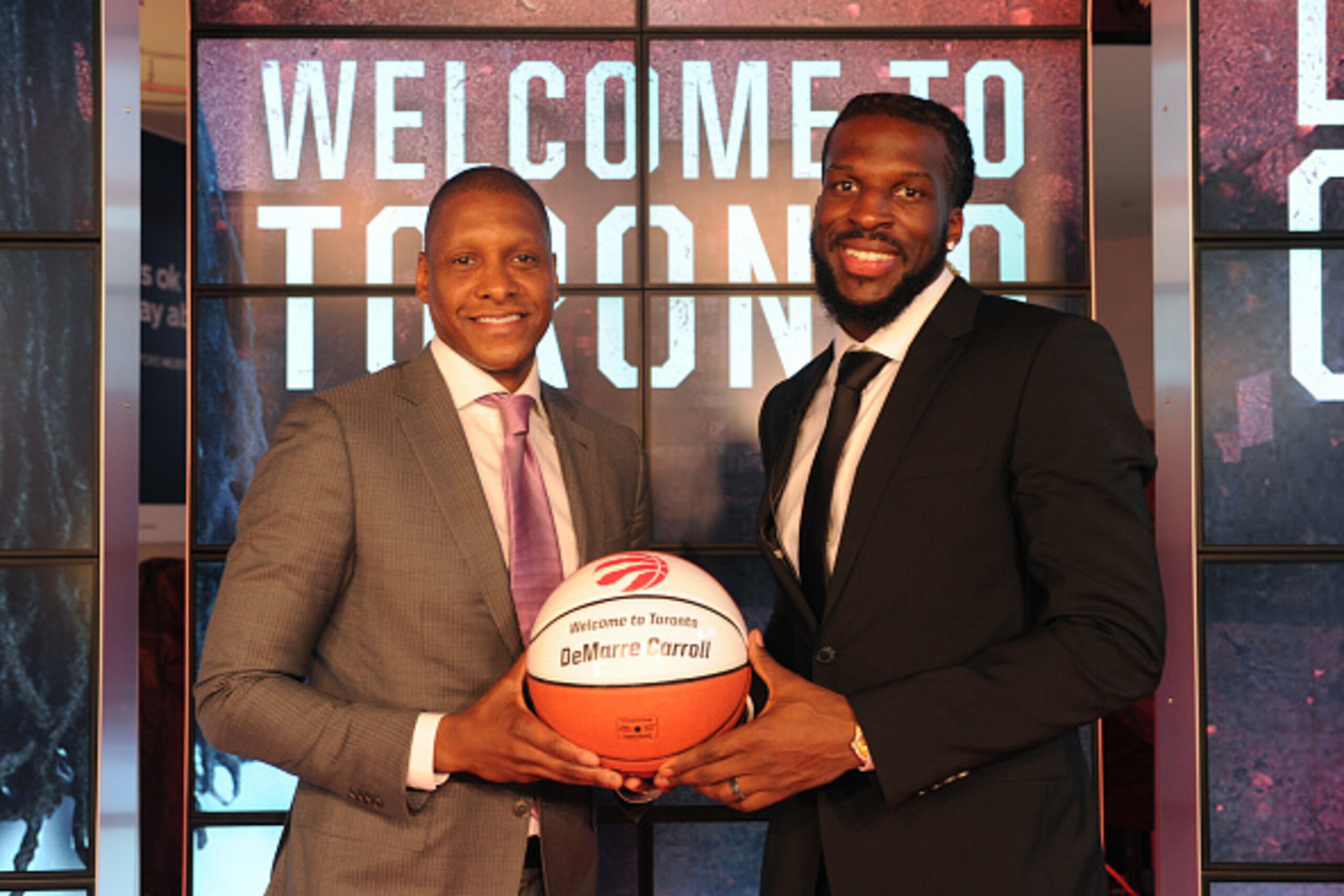 TORONTO, CANADA - JULY 9:  Masai Ujiri, GM of the Toronto Raptors, introduces DeMarre Carroll during a press conference on July 9, 2015 at the Air Canada Centre in Toronto, Ontario, Canada.  NOTE TO USER: User expressly acknowledges and agrees that, by do