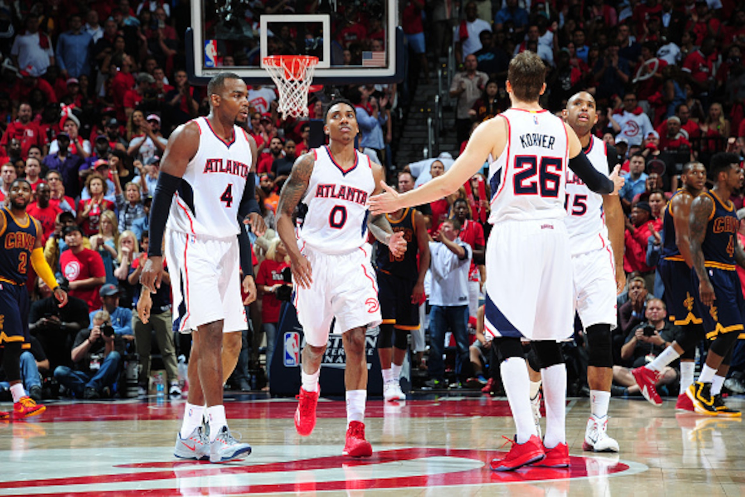 ATLANTA, GA - MAY 20: Kyle Korver #26 high fives teammates Paul Millsap #4, Jeff Teague #0 and Al Horford #15 of the Atlanta Hawks during Game One of the Eastern Conference Finals against the Cleveland Cavaliers during the NBA Playoffs on May 20, 2015 at 