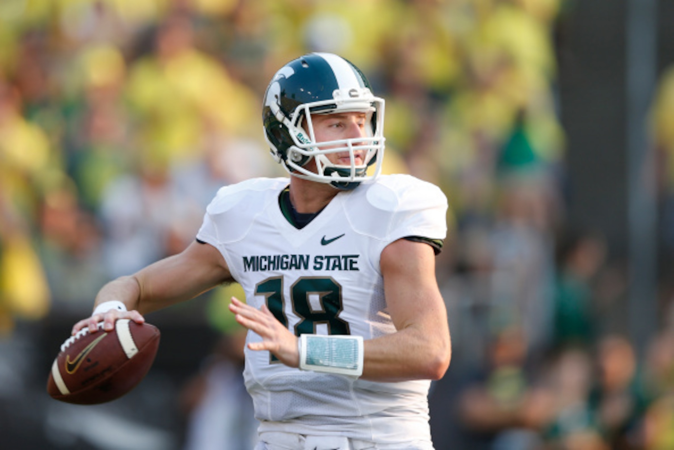 EUGENE, OR - SEPTEMBER 6: Connor Cook #18 of the Michigan State Spartans looks to pass the ball against the Oregon Ducks during the game at Autzen Stadium on September 6, 2014 in Eugene, Oregon. Oregon won 46-27. (Photo by Joe Robbins/Getty Images)