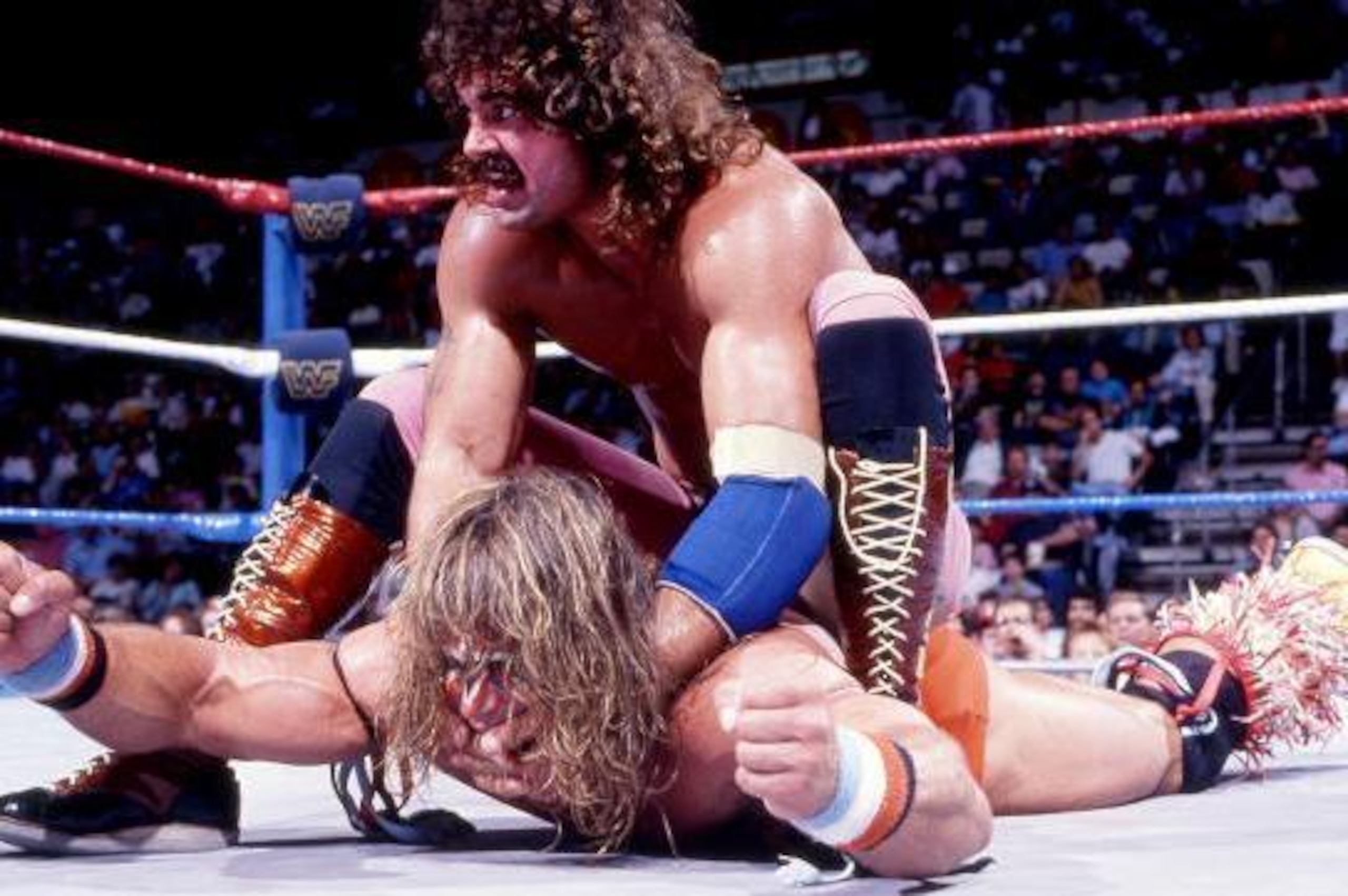 Rick Rude grounds Ultimate Warrior.