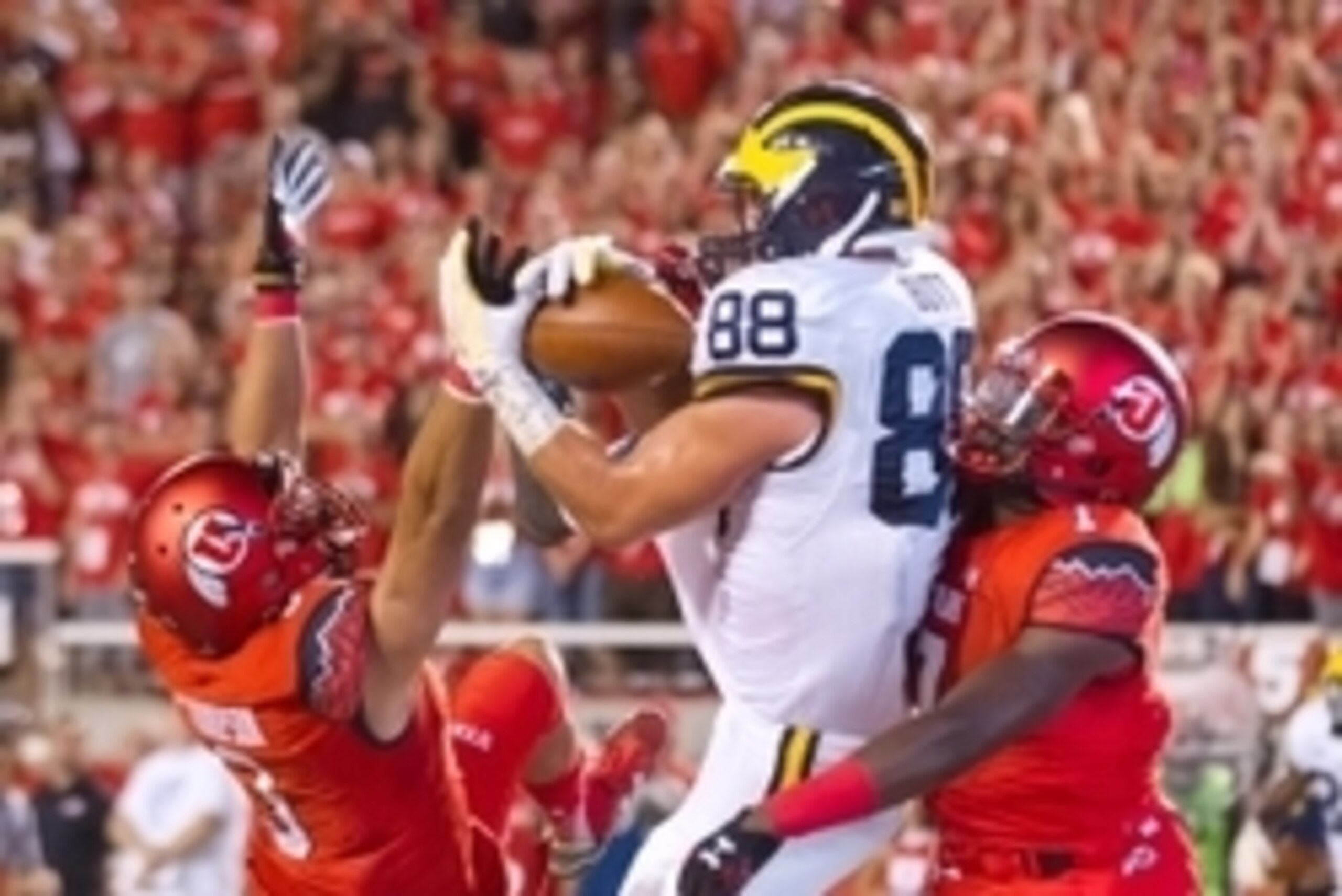 Sep 3, 2015; Salt Lake City, UT, USA; Michigan Wolverines tight end Jake Butt (88) catches a touchdown pass while defended by Utah Utes defensive back Jason Thompson (3) and defensive back Andre Godfrey (7) during the second half at Rice-Eccles Stadium. U