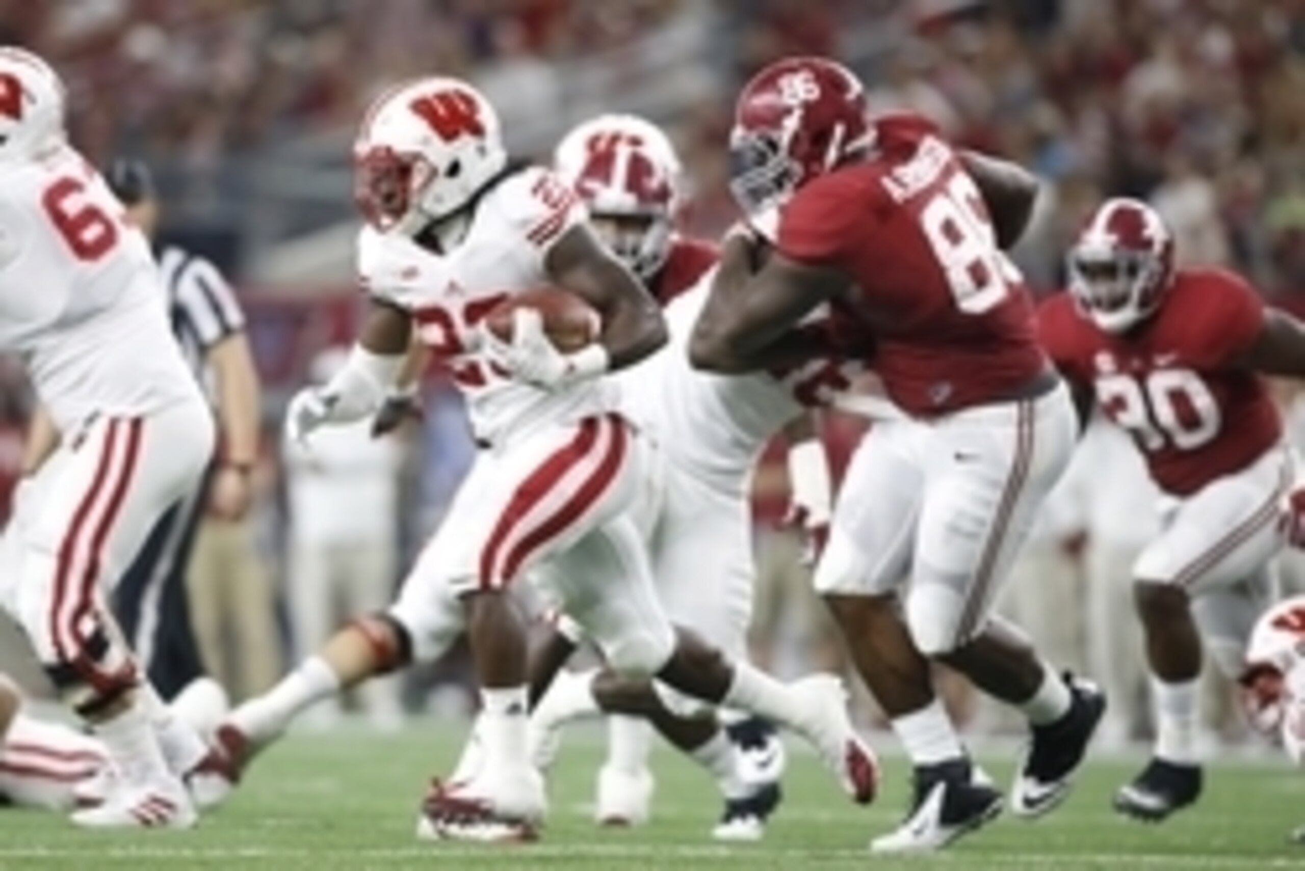 Sep 5, 2015; Arlington, TX, USA; Wisconsin Badgers running back Dare Ogunbowale (23) runs against Alabama Crimson Tide defensive lineman A'Shawn Robinson (86) during the second quarter at AT&T Stadium. Mandatory Credit: Tim Heitman-USA TODAY Sports