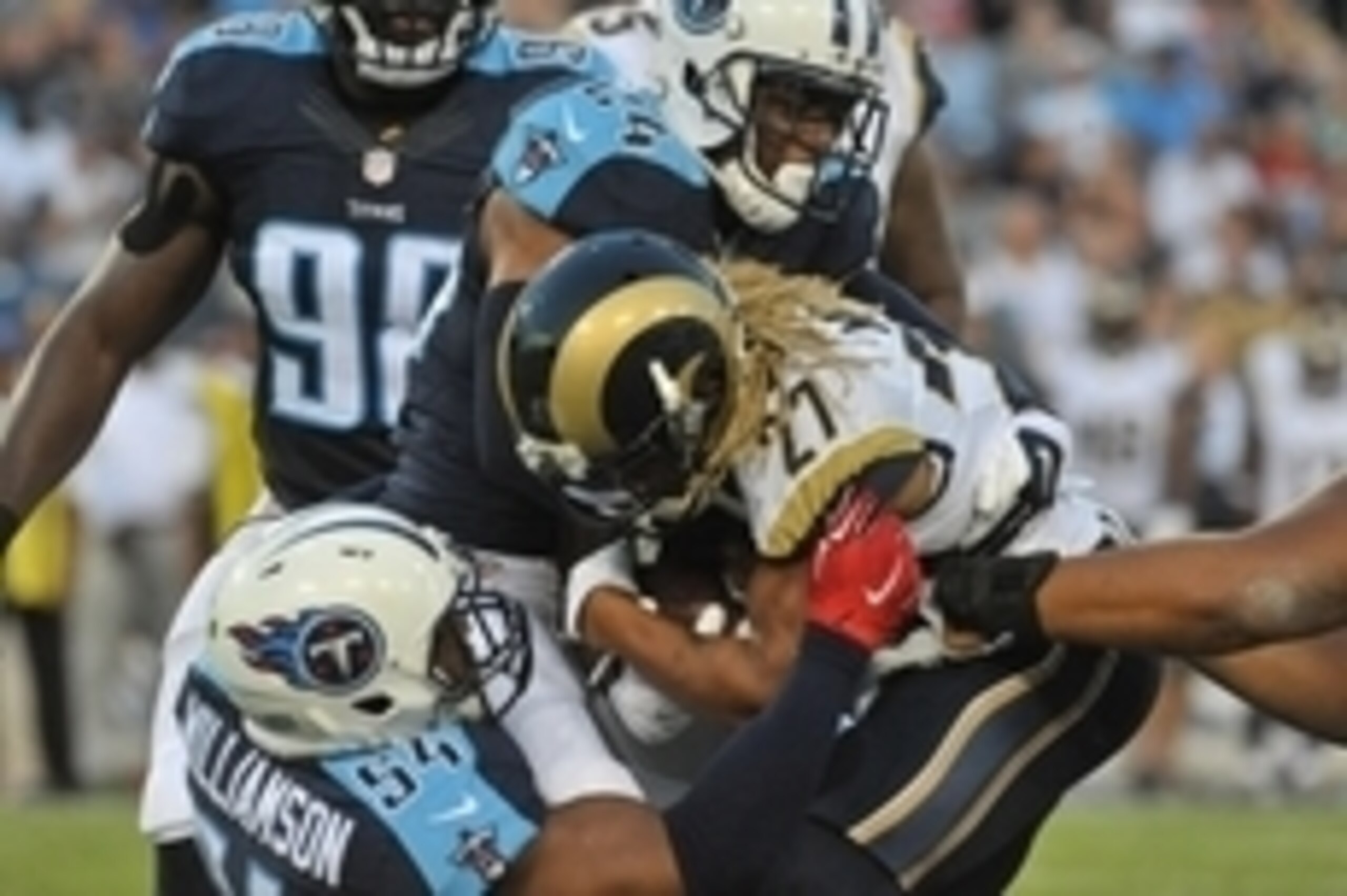 Aug 23, 2015; Nashville, TN, USA; St. Louis Rams running back Tre Mason (27) is tackled by Tennessee Titans inside linebacker Avery Williamson (54) and Titans cornerback Coty Sensabaugh (24) during the first half at Nissan Stadium. Mandatory Credit: Jim B