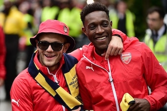 Arsenal's English midfielder Jack Wilshere and Arsenal's English striker Danny Welbeck react during the Arsenal victory parade in London on May 31, 2015, following their win in the English FA Cup final football match on May 30, 2014 against Aston Villa. A
