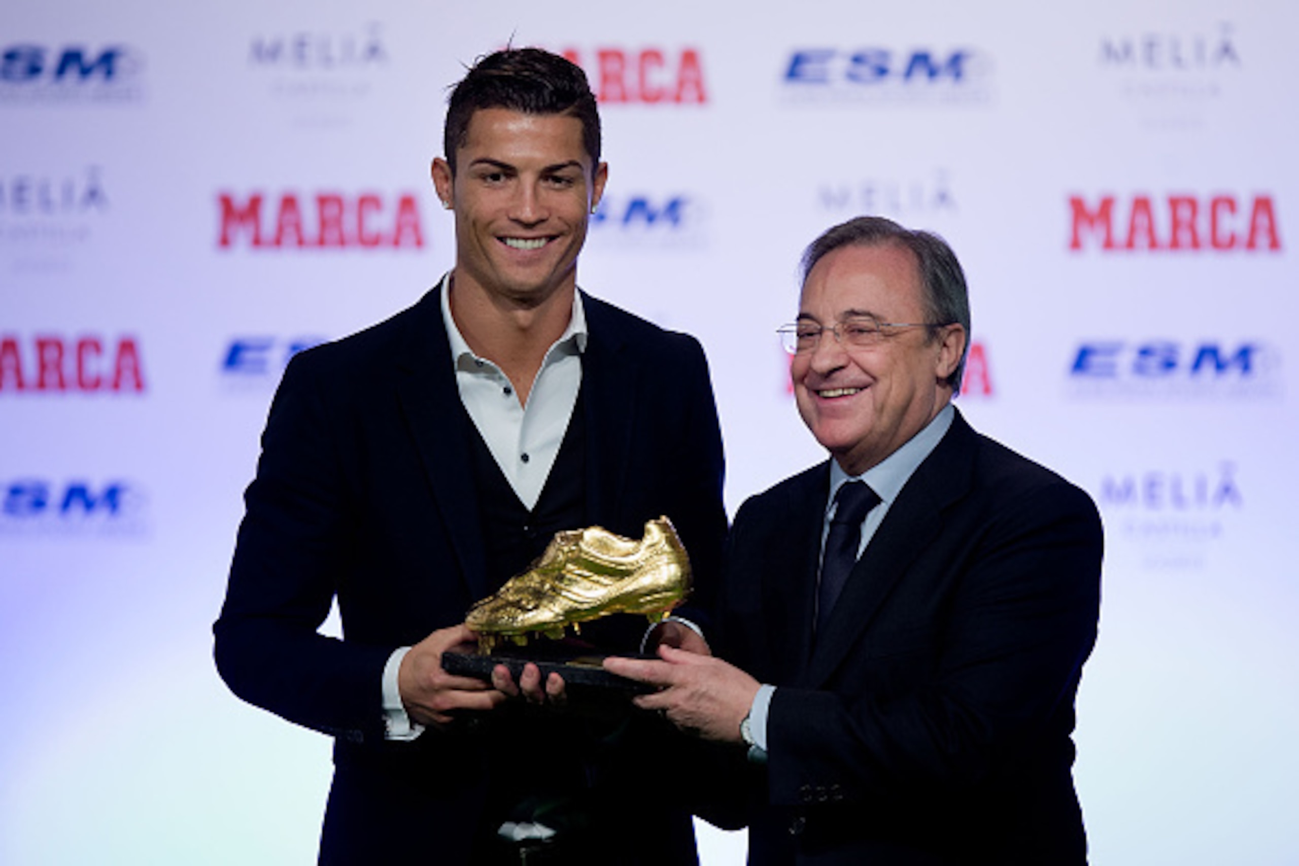 MADRID, SPAIN - NOVEMBER 05:  Cristiano Ronaldo (L) of Real Madrid CF receives the Golden Boot award from president of Real Madrid CF Florentino Perez (R) at Melia Castilla hotel on November 5, 2014 in Madrid, Spain. Cristiano Ronaldo's 31 strikes in La L
