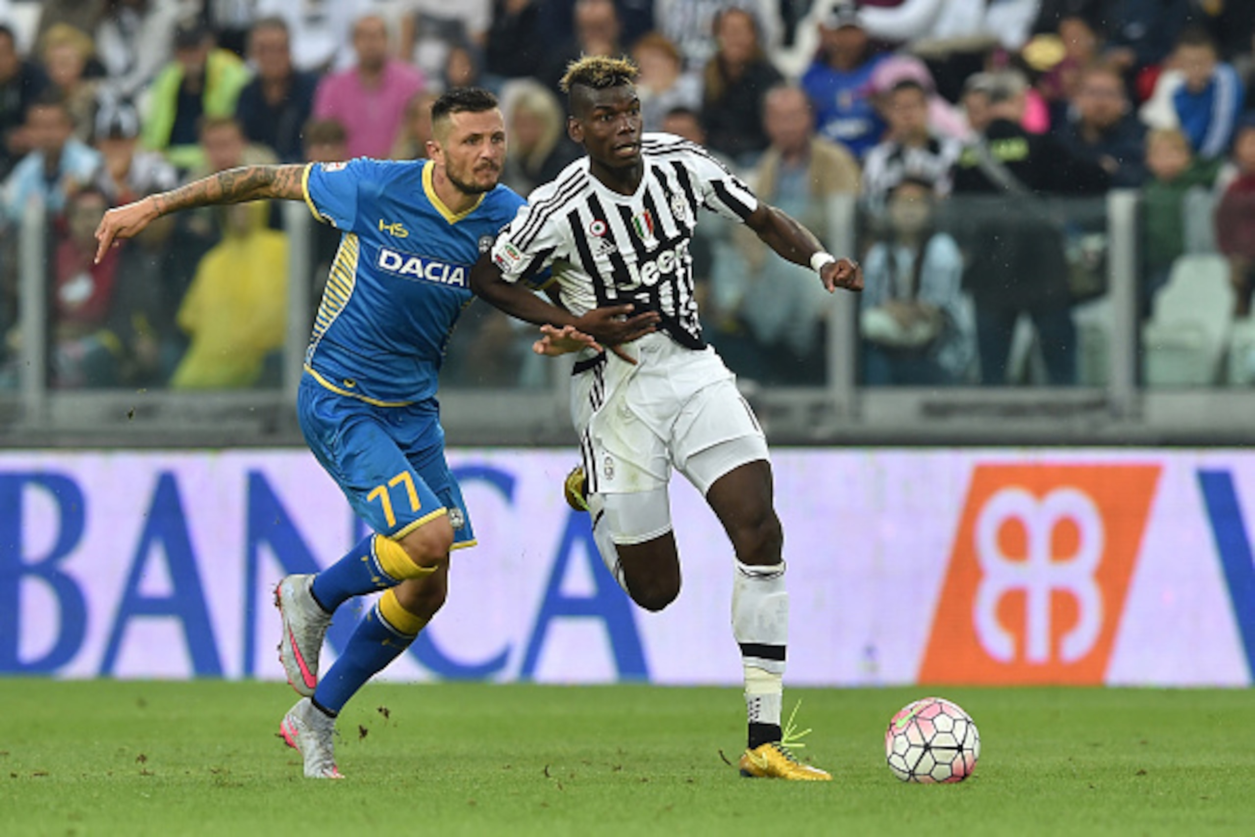 TURIN, ITALY - AUGUST 23:  Paul Pogba (R) of Juventus FC is challenged by Cyril Thereau of Udinese Calcio during the Serie A match between Juventus FC and Udinese Calcio at Juventus Arena on August 23, 2015 in Turin, Italy.  (Photo by Valerio Pennicino/Ge