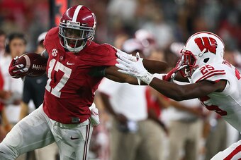 ARLINGTON, TX - SEPTEMBER 05:  Kenyan Drake #17 of the Alabama Crimson Tide runs for a touchdown past Derrick Tindal #25 of the Wisconsin Badgers in the fourth quarter during the Advocare Classic at AT&T Stadium on September 5, 2015 in Arlington, Texas.  