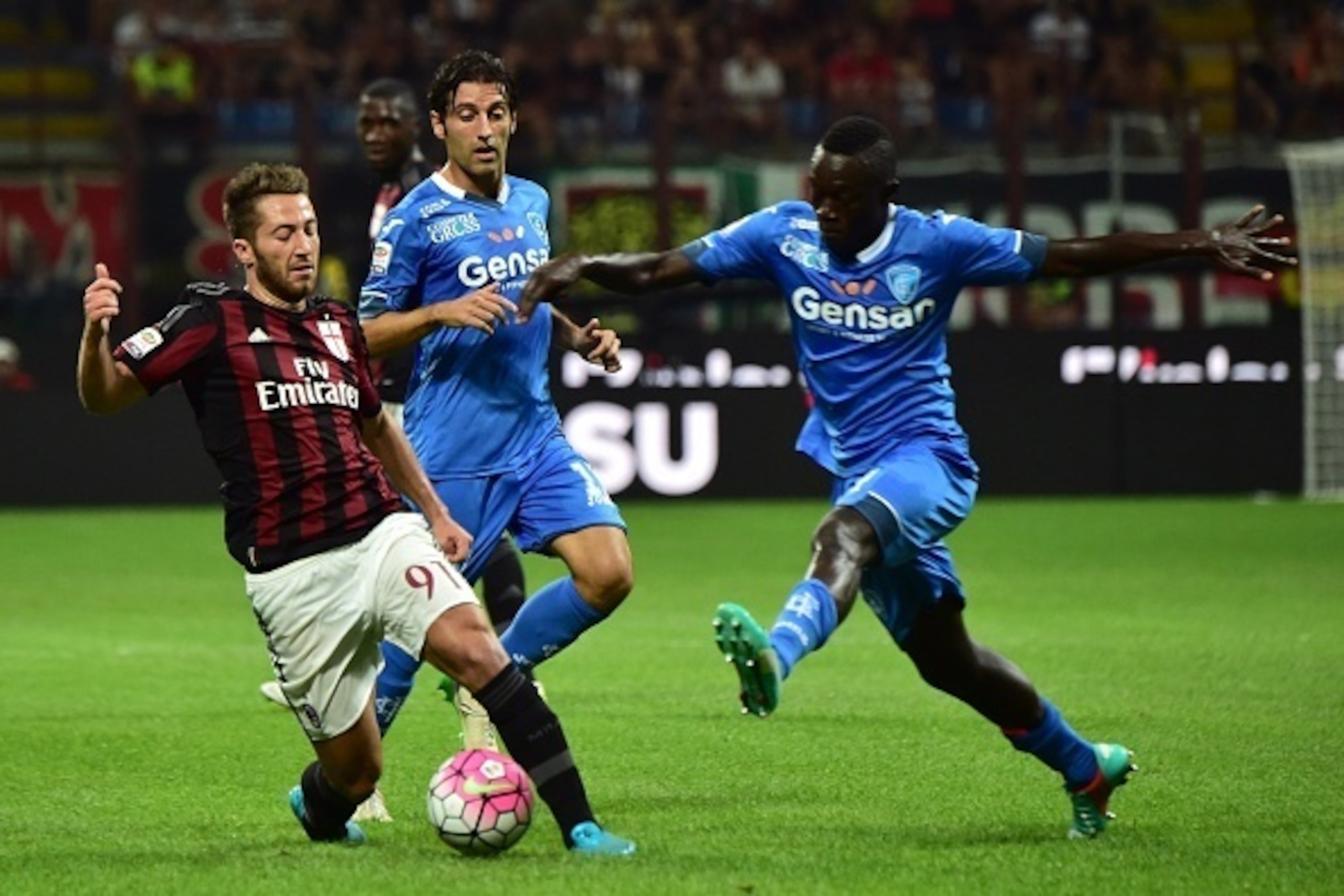 AC Milan's midfielder from Italy Andrea Bertolacci (L) fights for the ball with Empoli's midfielder from Senegal Assane Diousse El Hadji during the Serie A football match between AC Milan and Empoli  at San Siro Stadium in Milan on August 29, 2015. AFP PH