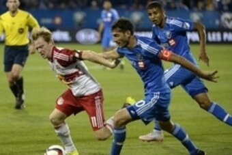 Aug 5, 2015; Montreal, Quebec, CAN; Montreal Impact midfielder Ignacio Piatti (10) and New York Red Bulls midfielder Dax McCarty (11) battle for the ball during the second half at Stade Saputo. Mandatory Credit: Eric Bolte-USA TODAY Sports