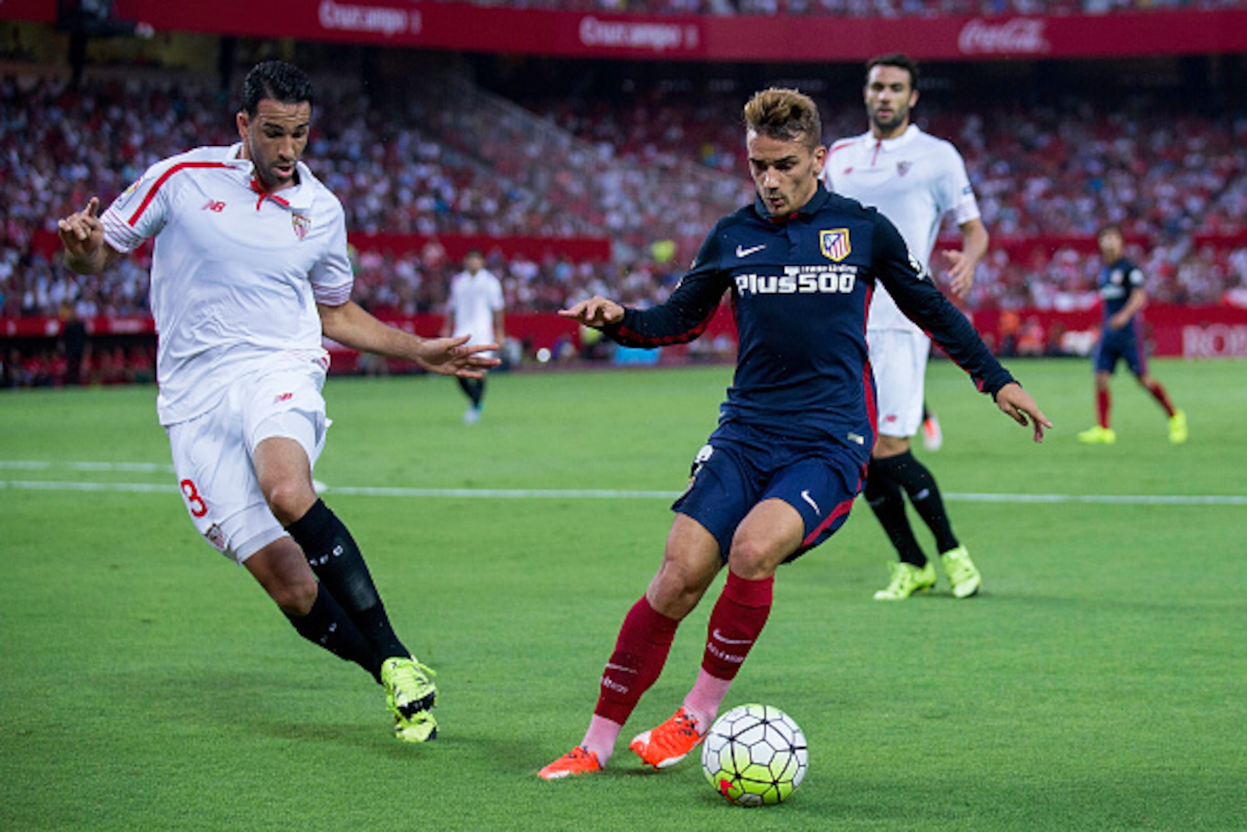 SEVILLE, SPAIN - AUGUST 30: Antoine Griezmann (R) of Atletico de Madrid competes for the ball with Adil Rami (L) of Sevilla FC during the La Liga match between Sevilla FC and Club Atletico de Madrid at Estadio Ramon Sanchez Pizjuan on August 30, 2015 in S