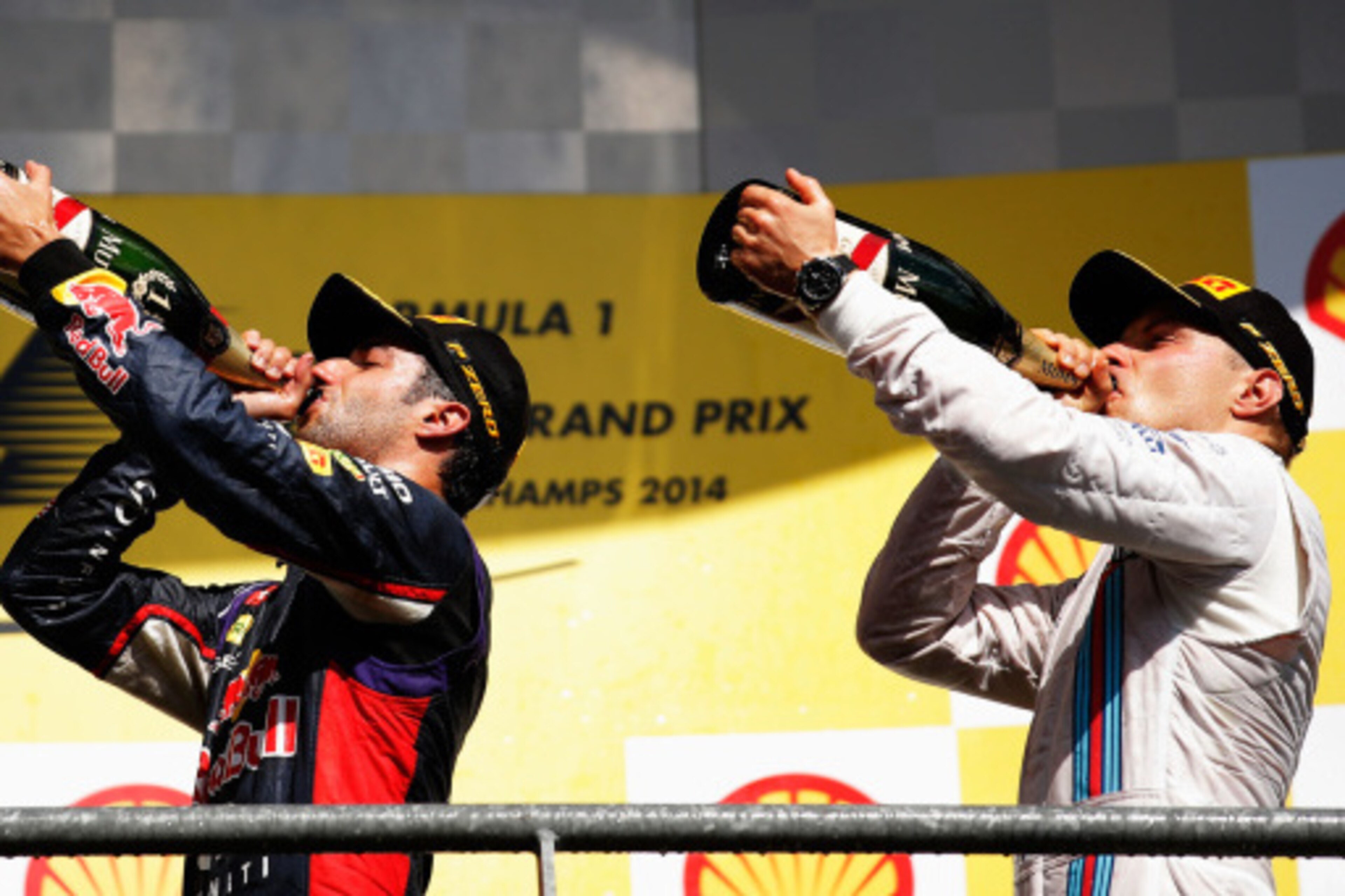 SPA, BELGIUM - AUGUST 24:  Daniel Ricciardo of Australia and Infiniti Red Bull Racing celebrates on the podium next to Valtteri Bottas of Finland and Williams after winning the Belgian Grand Prix at Circuit de Spa-Francorchamps on August 24, 2014 in Spa, 