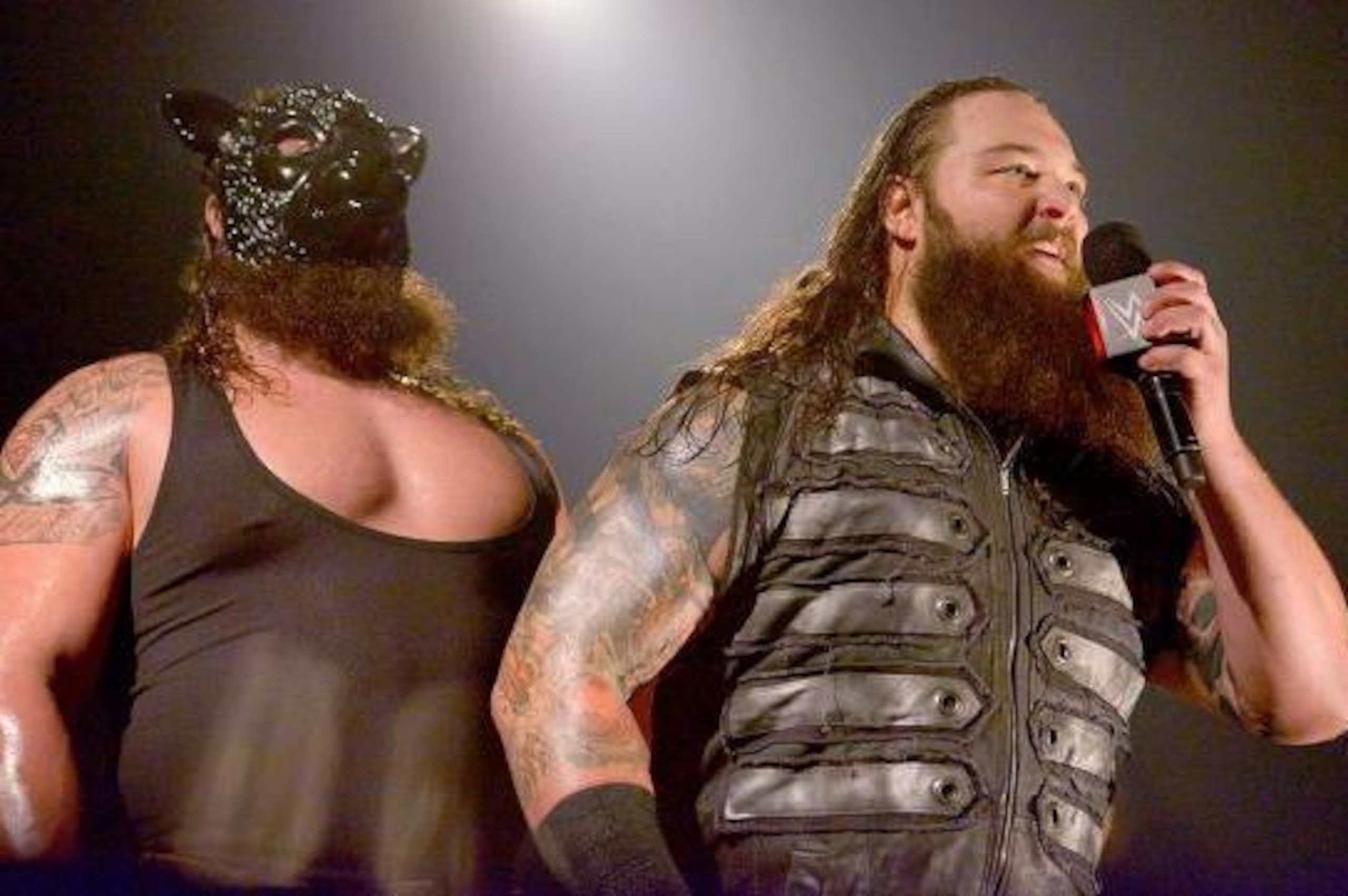 Braun Strowman watches on as Bray Wyatt speaks.