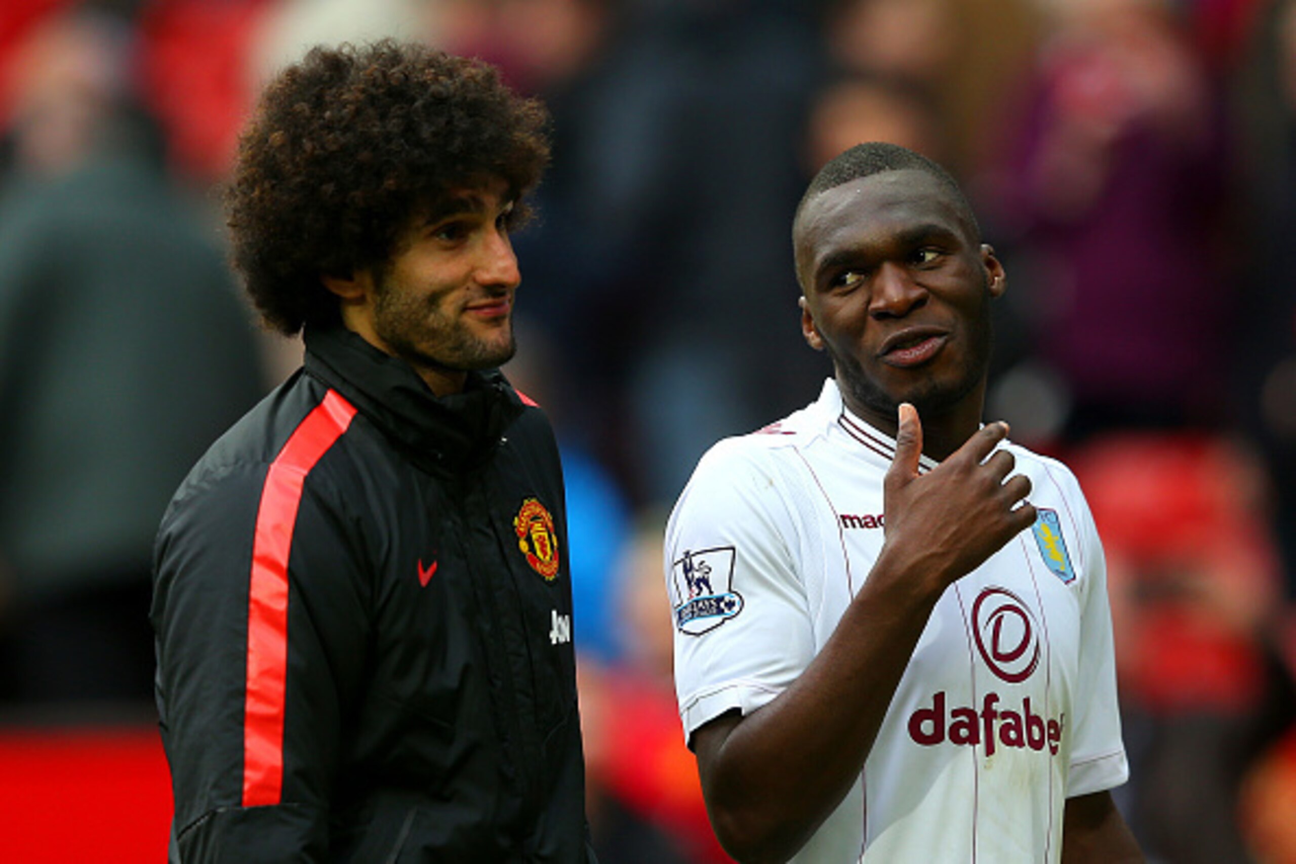 MANCHESTER, ENGLAND - APRIL 04:  Christian Benteke of Aston Villa speaks with Marouane Fellaini of Manchester United after the Barclays Premier League match between Manchester United and Aston Villa at Old Trafford on April 4, 2015 in Manchester, England.