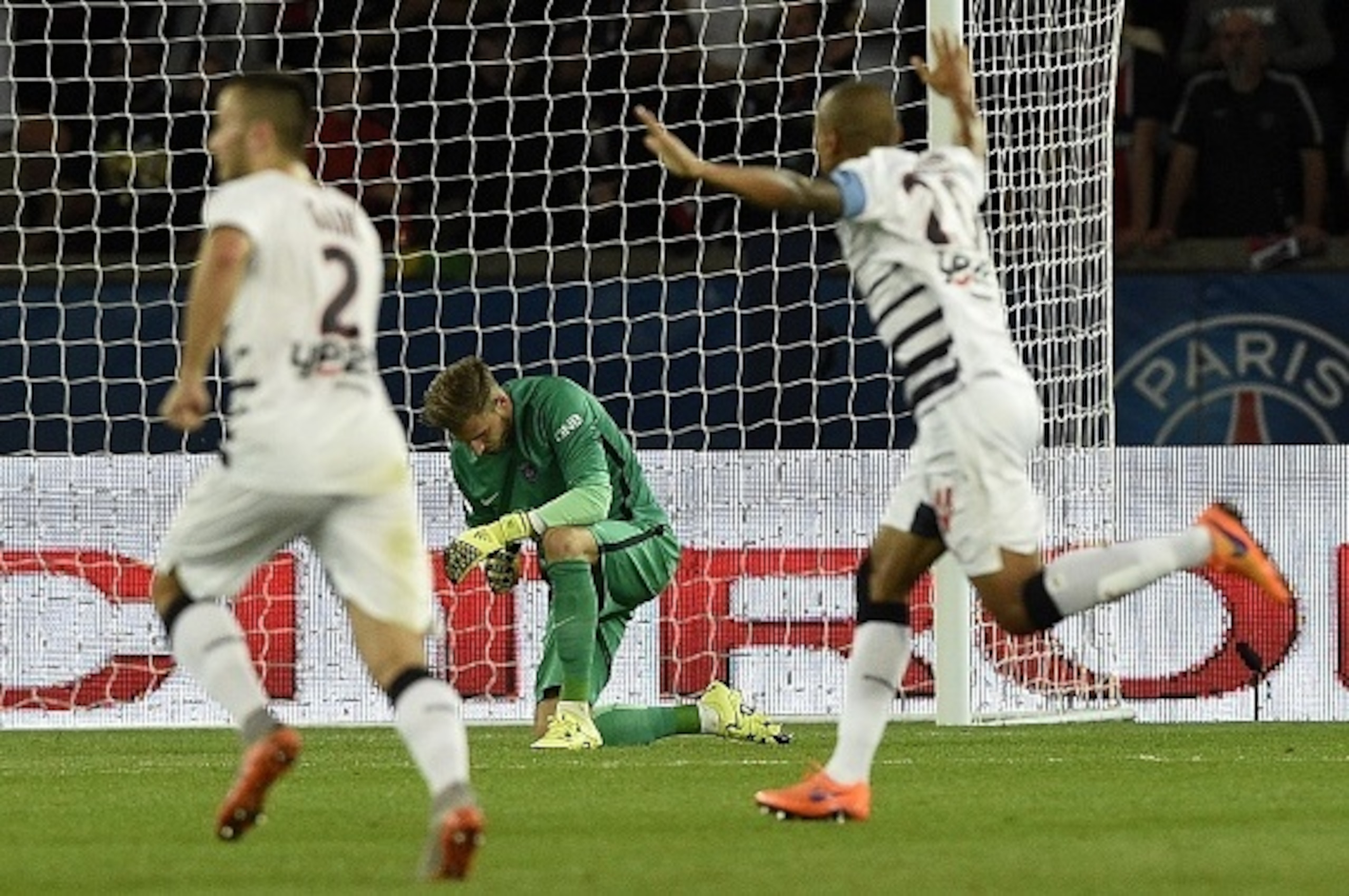 Bordeaux's players celebrate past Paris Saint-Germain's German goalkeeper Kevin Trapp after scoring a goal during the French L1 football match between Paris Saint-Germain (PSG) and Bordeaux at the Parc des Princes stadium in Paris on September 11, 2015. A