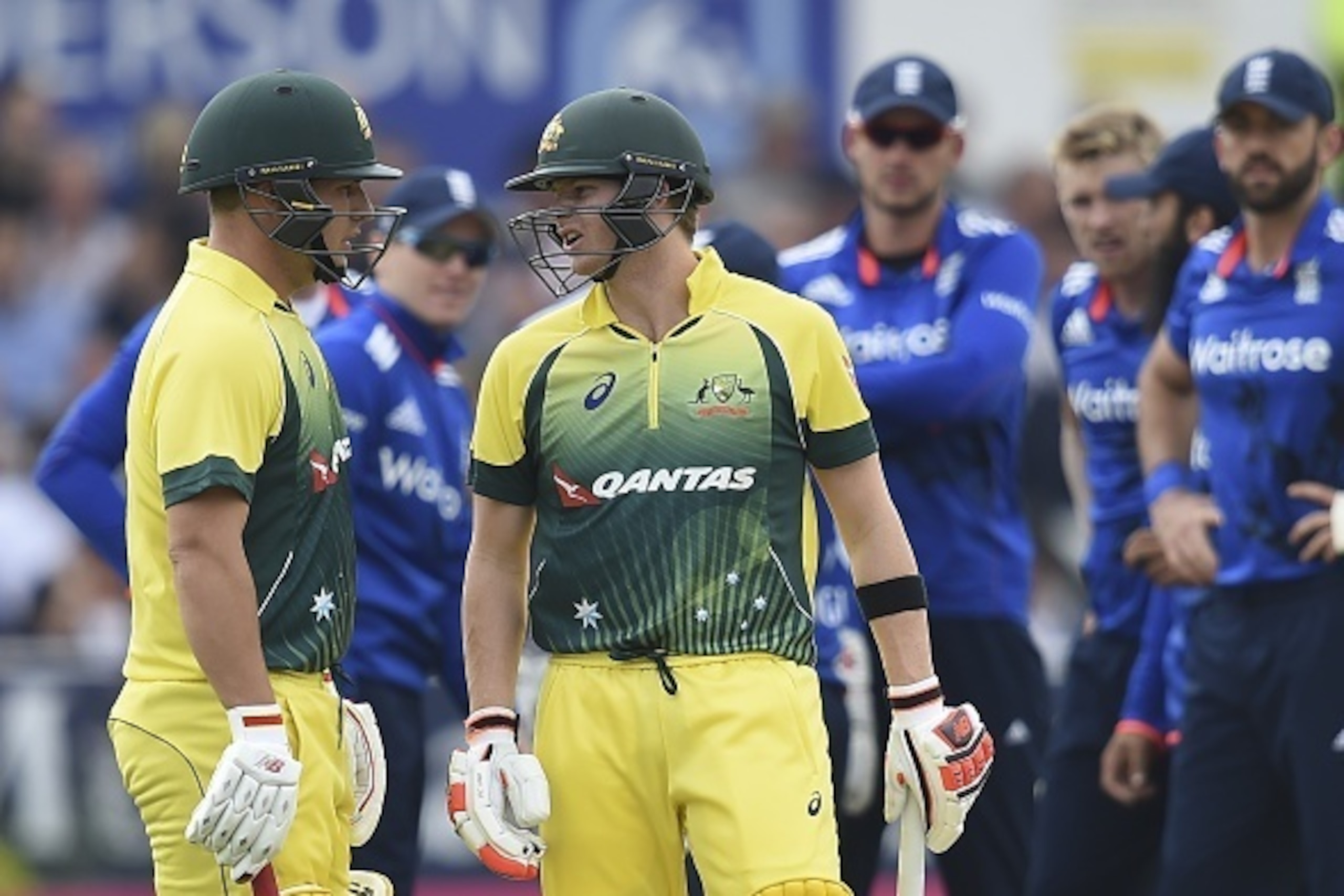 Australia's captain Steven Smith (R) talks to Australia's Aaron Finch (L) about whether to review a decision before leaving the field out lbw off the bowling of England's David Willey for five runs during the fourth one day international (ODI) cricket mat