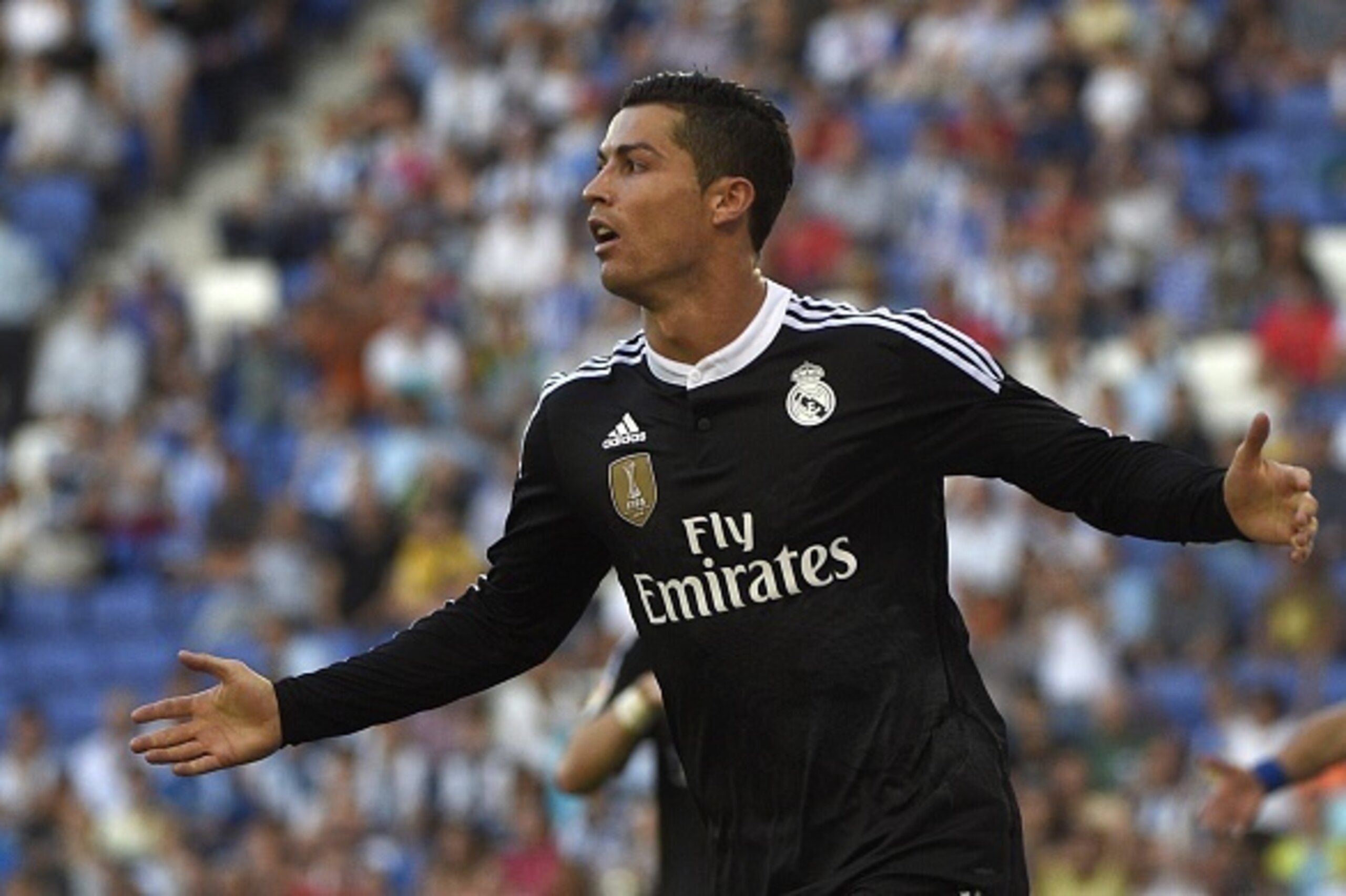 Real Madrid's Portuguese forward Cristiano celebrates after scoring a goal during the Spanish league football match RCD Espanyol vs Real Madrid CF at the Cornella-El Prat stadium in Cornella de Llobregat on May 17, 2015.   AFP PHOTO / LLUIS GENE        (P