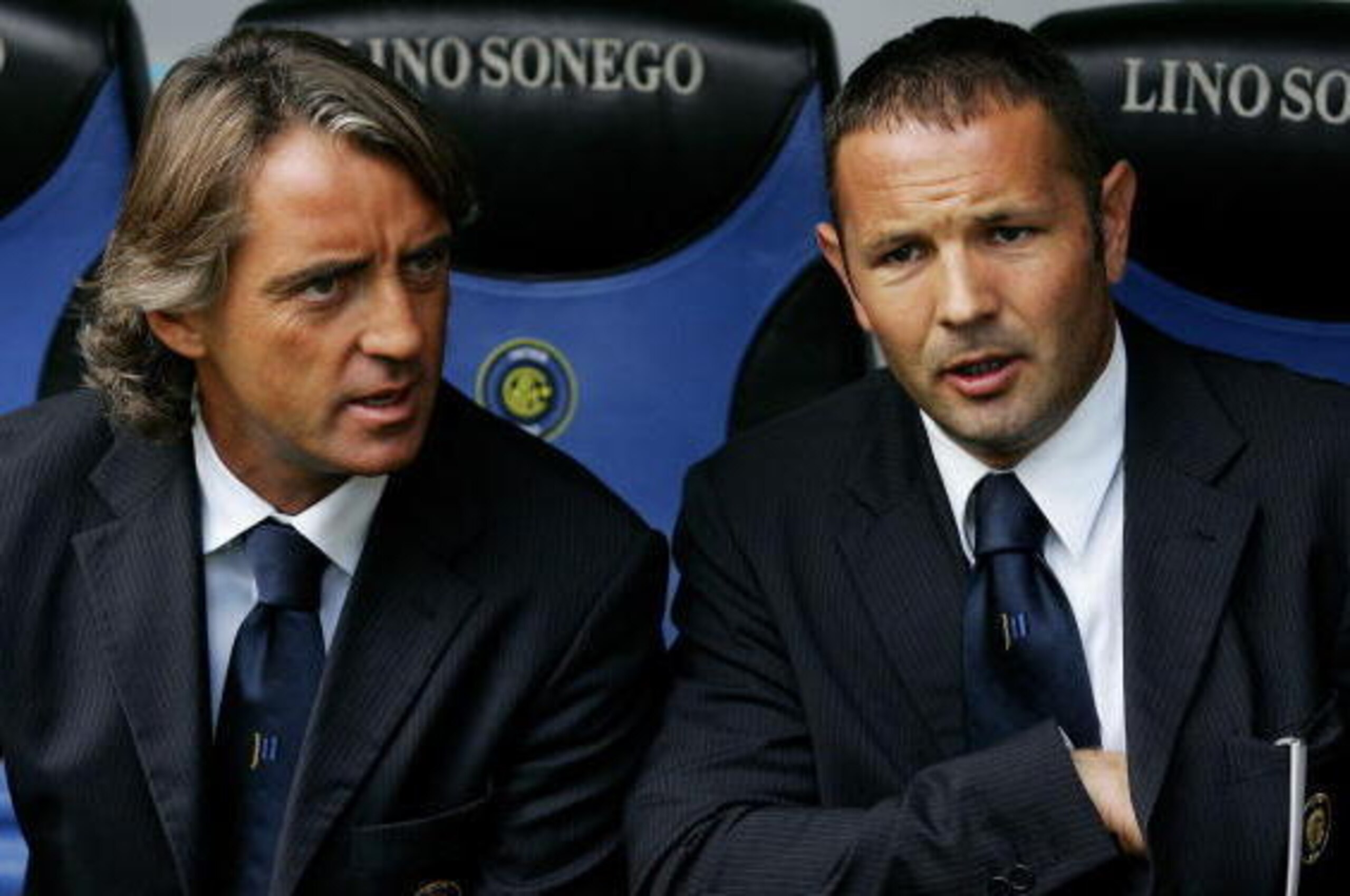 Milan, ITALY: Inter Milan's coach Roberto Mancini (L) speaks with his assistant coach Sinisa Mihajlovic before their Serie A football match against Chievo Verona at San Siro stadium in Milan, 24 September 2006. AFP PHOTO / Paco SERINELLI (Photo credit s Milan, ITALY: Inter Milan's coach Roberto Mancini (L) speaks with his assistant coach Sinisa Mihajlovic before their Serie A football match against Chievo Verona at San Siro stadium in Milan, 24 September 2006. AFP PHOTO / Paco SERINELLI (Photo credit s