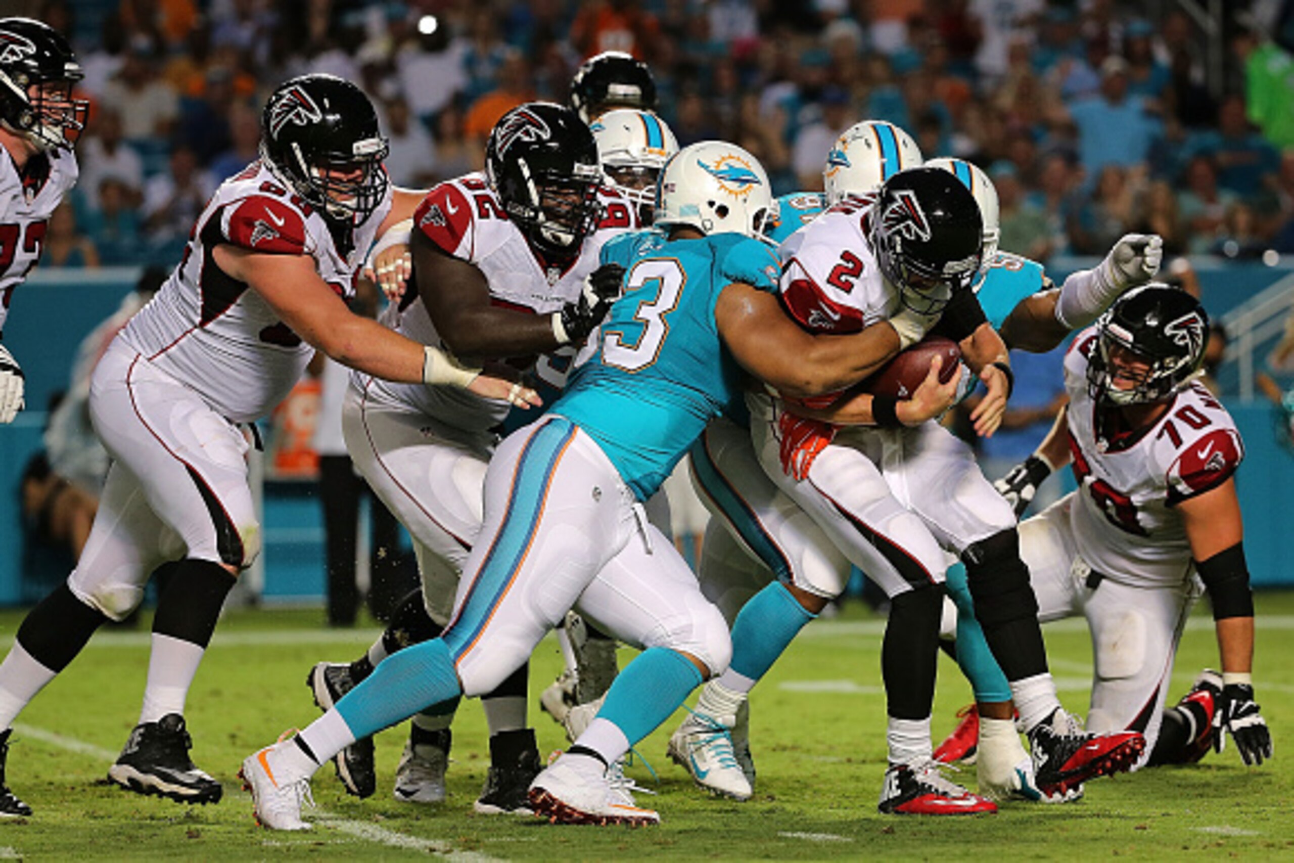 MIAMI GARDENS, FL - AUGUST 29:  Matt Ryan #2 of the Atlanta Falcons is sacked by Cameron Wake #91 and Ndamukong Suh #93 of the Miami Dolphins during a preseason game  at Sun Life Stadium on August 29, 2015 in Miami Gardens, Florida.  (Photo by Mike Ehrman