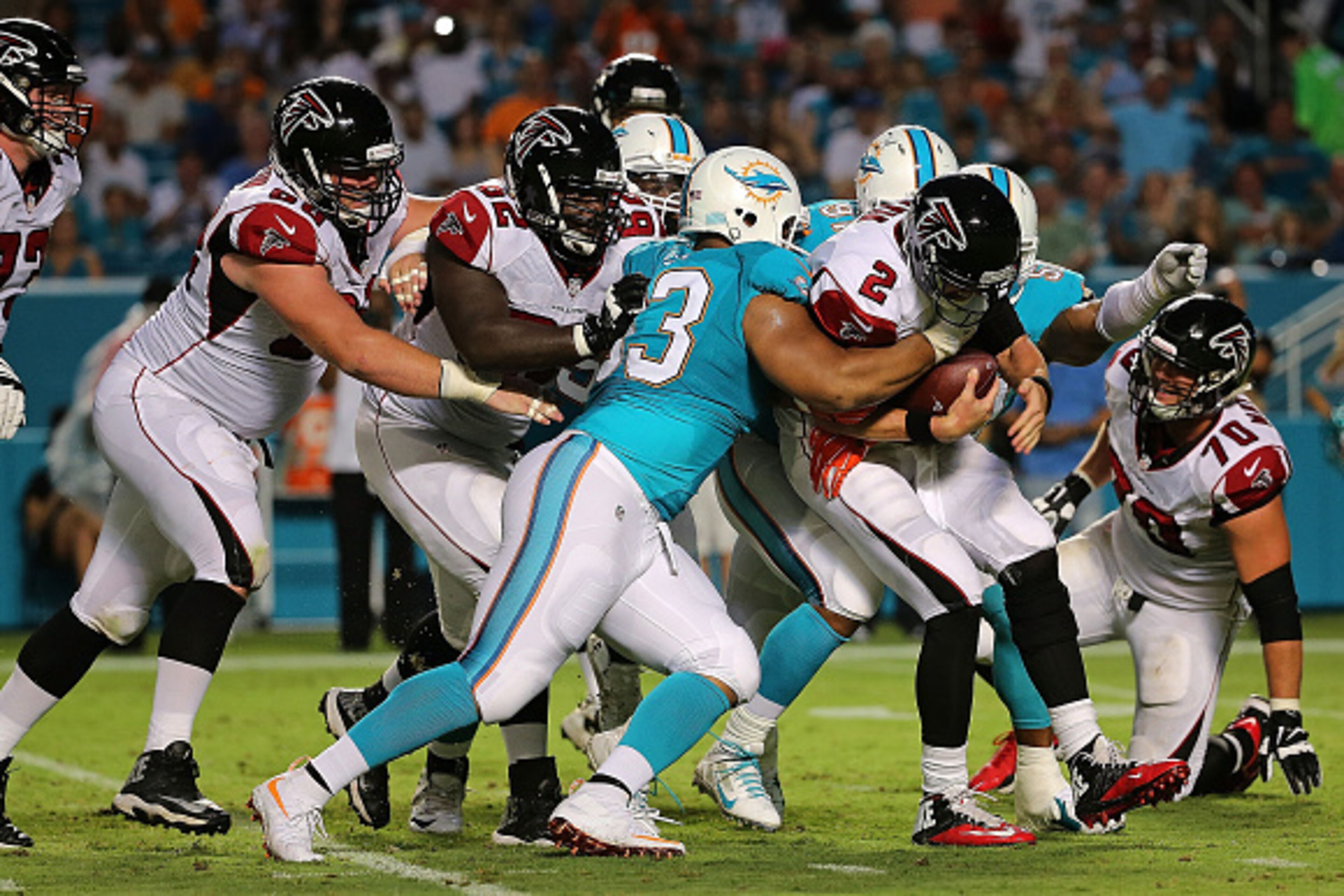 MIAMI GARDENS, FL - AUGUST 29:  Matt Ryan #2 of the Atlanta Falcons is sacked by Cameron Wake #91 and Ndamukong Suh #93 of the Miami Dolphins during a preseason game  at Sun Life Stadium on August 29, 2015 in Miami Gardens, Florida.  (Photo by Mike Ehrman