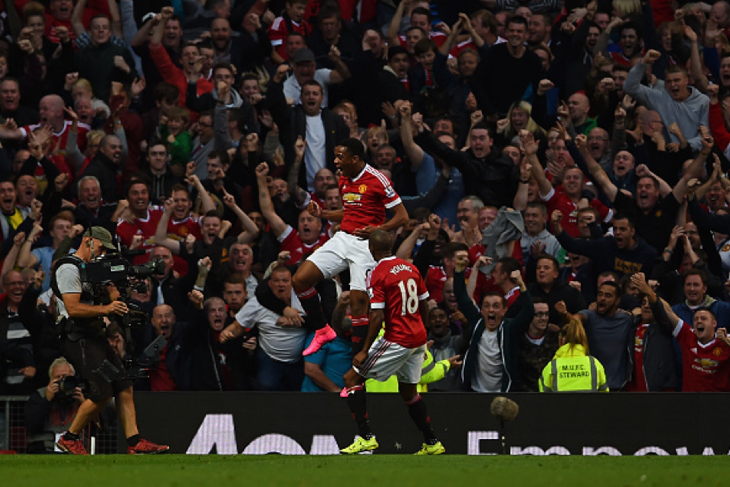MANCHESTER, ENGLAND - SEPTEMBER 12:  Anthony Martial of Manchester United celebrates scoring his team's third goal with Ashley Young during the Barclays Premier League match between Manchester United and Liverpool at Old Trafford on September 12, 2015 in 