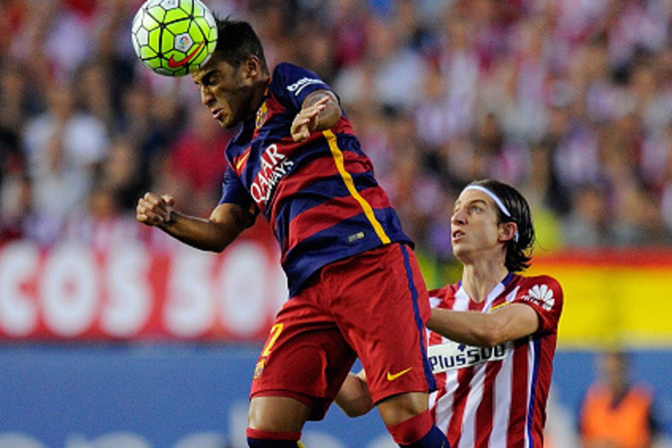 MADRID, SPAIN - SEPTEMBER 12:  Rafinha of FC Barcelona heads the ball beside Felipe Luis of Club Atletico de Madrid during the La Liga match between Club Atletico de Madrid and FC Barcelona at Vicente Calderon Stadium on September 12, 2015 in Madrid, Spai