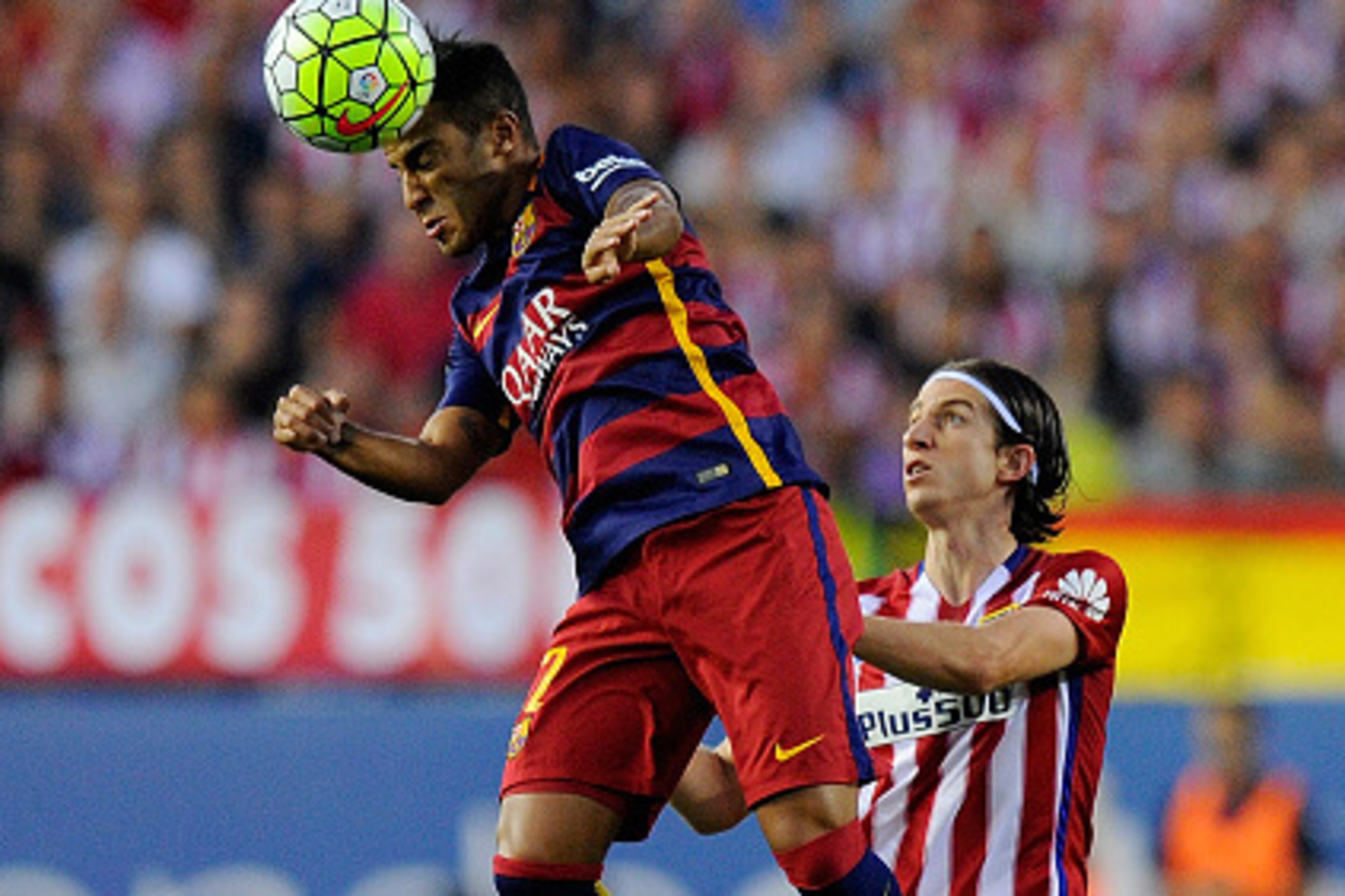 MADRID, SPAIN - SEPTEMBER 12:  Rafinha of FC Barcelona heads the ball beside Felipe Luis of Club Atletico de Madrid during the La Liga match between Club Atletico de Madrid and FC Barcelona at Vicente Calderon Stadium on September 12, 2015 in Madrid, Spai