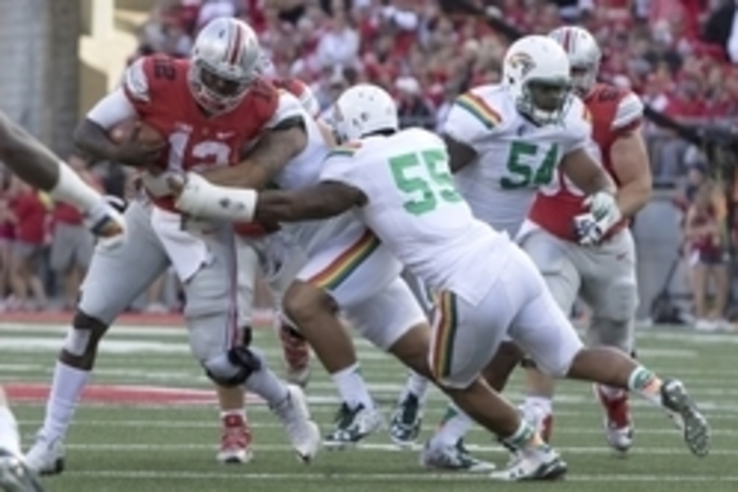 Sep 12, 2015; Columbus, OH, USA; Ohio State Buckeyes quarterback Cardale Jones (12) runs the ball and is tackled by Hawaii Warriors defensive lineman Kennedy Tulimasealii (90) and linebacker Makani Kema-Kaleiwahea (55) in the second half of the game at Oh