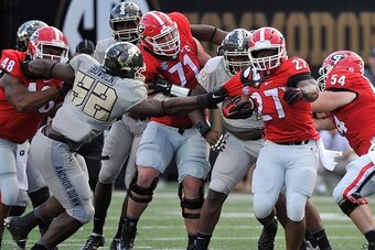 NASHVILLE, TN - SEPTEMBER 12:  Nigel Bowden #52 of the Vanderbilt Commodores grabs the jersey of tailback Nick Chubb #27 of the Georgia Bulldogs during the second half at Vanderbilt Stadium on September 12, 2015 in Nashville, Tennessee.  (Photo by Frederi