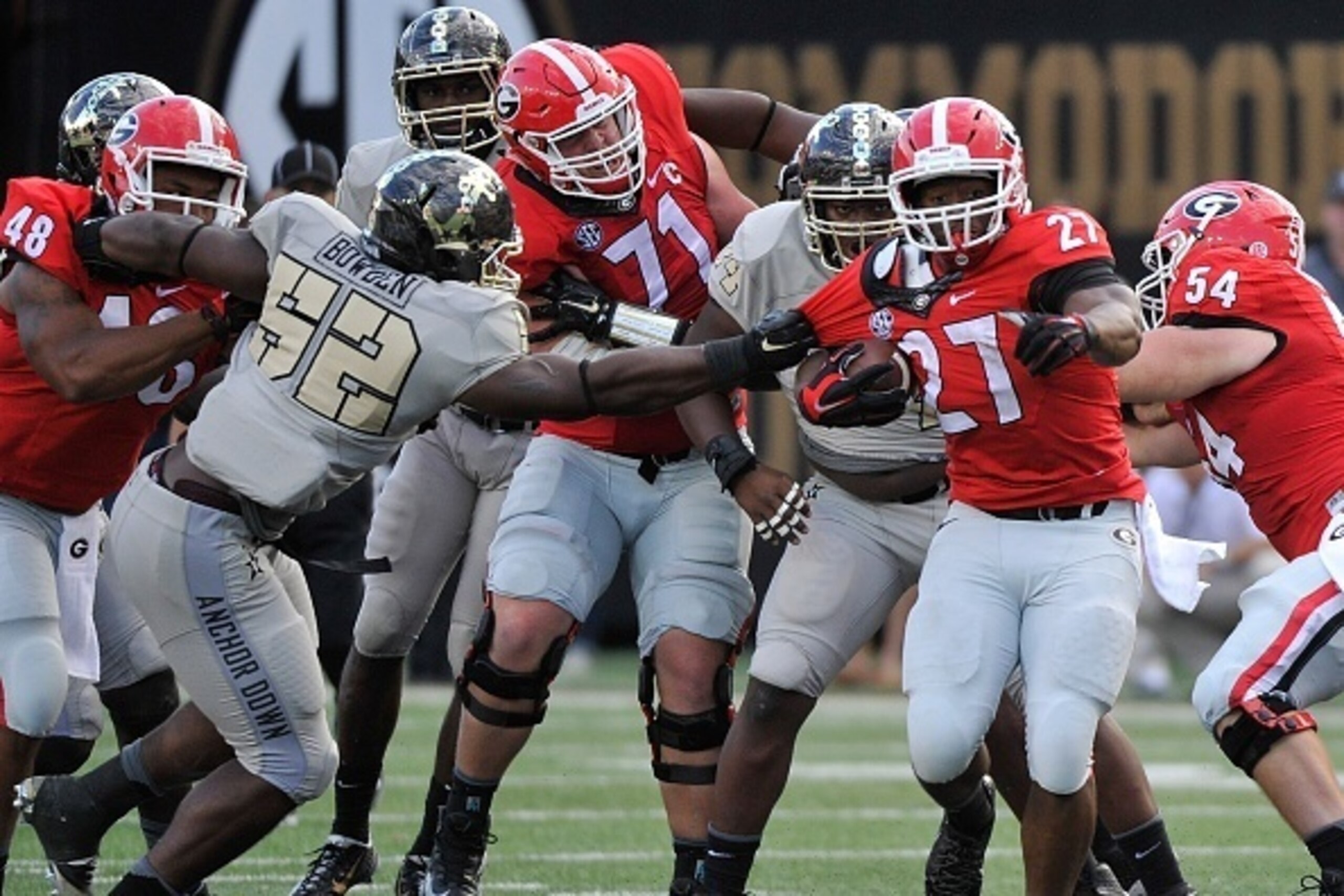 NASHVILLE, TN - SEPTEMBER 12:  Nigel Bowden #52 of the Vanderbilt Commodores grabs the jersey of tailback Nick Chubb #27 of the Georgia Bulldogs during the second half at Vanderbilt Stadium on September 12, 2015 in Nashville, Tennessee.  (Photo by Frederi