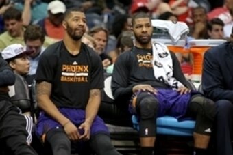 Apr 7, 2015; Atlanta, GA, USA; Phoenix Suns forward Markieff Morris (left) and forward Marcus Morris (15) are shown on the bench in the fourth quarter of their game against the Atlanta Hawks at Philips Arena. The Hawks won 96-69. Mandatory Credit: Jason G