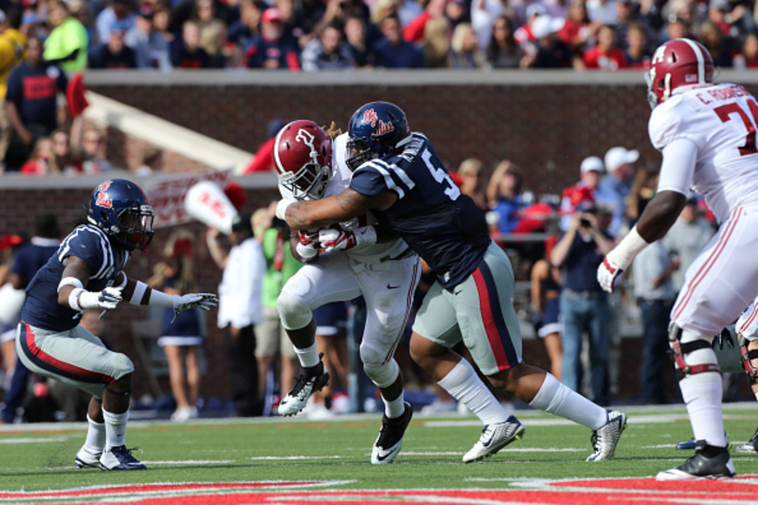 OXFORD, MS - OCTOBER 4: Robert Nkemdiche #5 of the Ole Miss Rebels tackles Derrick Henry #27 of the Alabama Crimson Tide on October 4, 2014 at Vaught-Hemingway Stadium in Oxford, Mississippi.  (Photo by Joe Murphy/Getty Images)