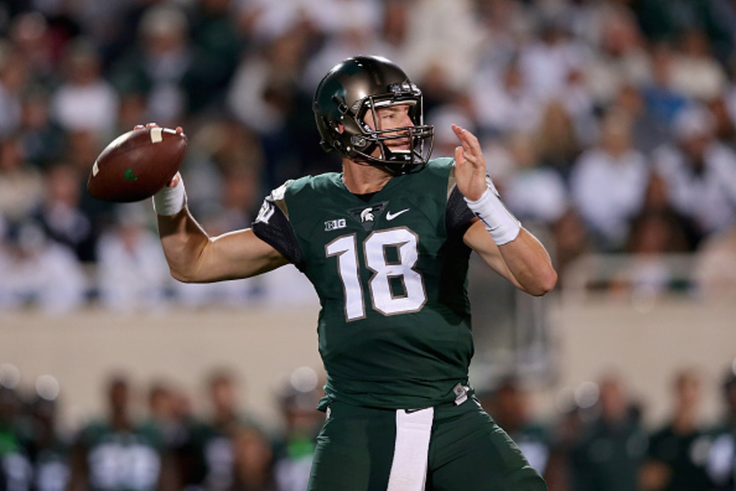 EAST LANSING, MI - SEPTEMBER 12:  Connor Cook #18 of the Michigan State Spartans drops back to pass against the Oregon Ducks during their game at Spartan Stadium on September 12, 2015 in East Lansing, Michigan.  (Photo by Streeter Lecka/Getty Images)