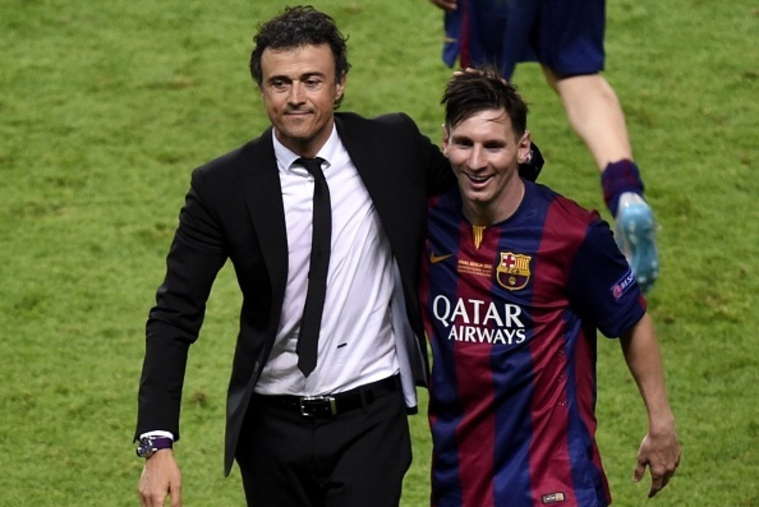 Barcelona's coach Luis Enrique and Barcelona's Argentinian forward Lionel Messi (R) celebrate after winning the UEFA Champions League Final football match between Juventus and FC Barcelona at the Olympic Stadium in Berlin on June 6, 2015.            AFP P