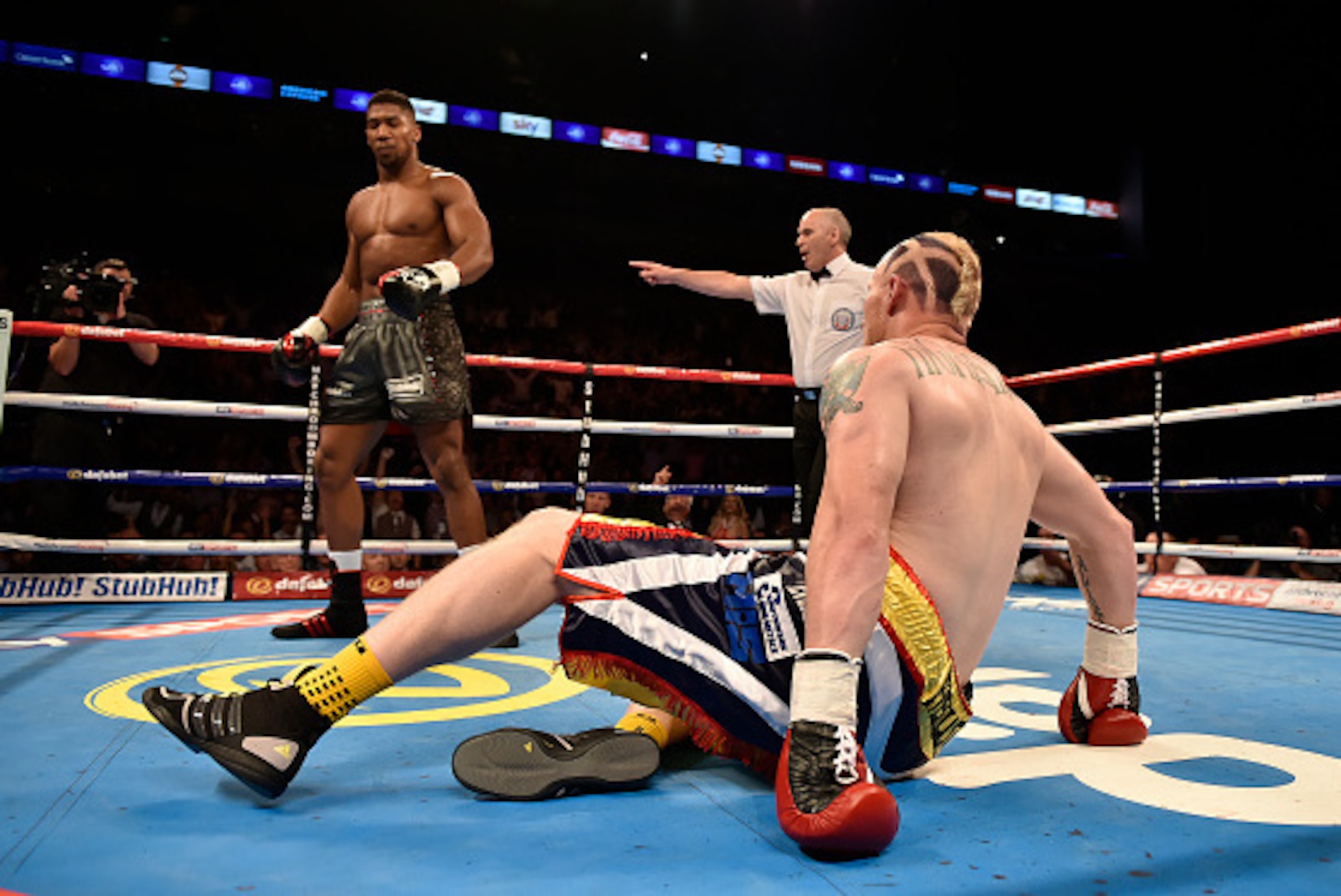 LONDON, ENGLAND - SEPTEMBER 12:  Anthony Joshua knocks down Gary Cornish in the first round of the WBC International Heavyweight title & vacant Commonwealth Heavyweight title during 'Heavy Duty' fight night at The O2 Arena on September 12, 2015 in London,