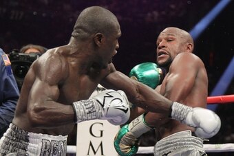 Floyd Mayweather Jr. (R) and Andre Berto fight for the WBO Welterweight World Title at the MGM Grand Garden Arena in Las Vegas, Nevada on September 12, 2015.  Floyd Mayweather earned a unanimous decision over Andre Berto on Saturday to claim his 49th and 