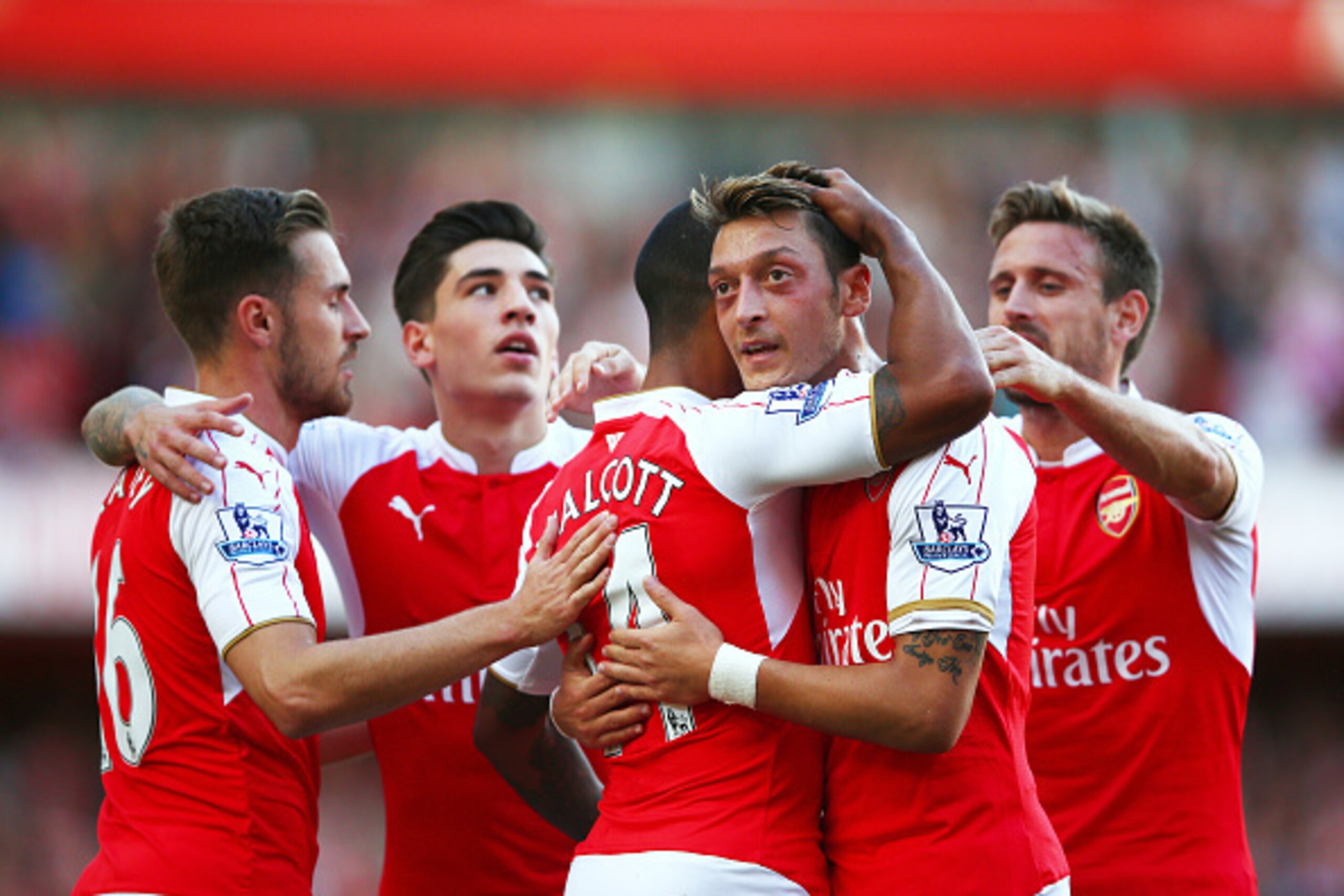 LONDON, ENGLAND - SEPTEMBER 12:  Theo Walcott of Arsenal celebrates scoring the opening goal with Mesut Oezil of Arsenal during the Barclays Premier League match between Arsenal and Stoke City at the Emirates Stadium on September 12, 2015 in London, Unite